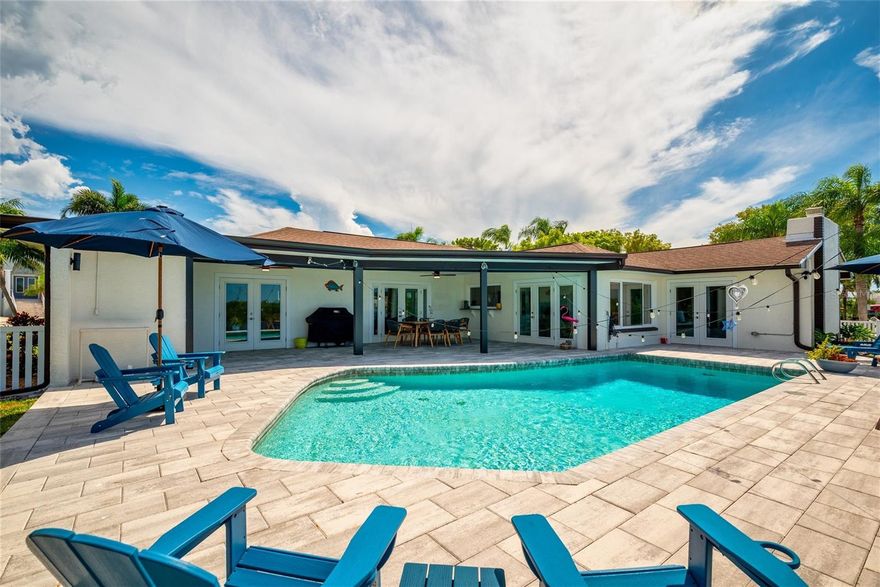 Florida luxury waterfront living at its finest! Most water frontage in the neighborhood at 122ft. This renovated home features soaring ceilings, an open floor plan and a chef's kitchen that flows seamlessly into the living and dining areas. A stunning stone fireplace and wall of windows showcase breathtaking water views, while the spacious game room with wood ceilings is perfect for entertaining. Remote controlled screen keeps the bugs out without losing the amazing view. Roof is two years old, new HVAC, gutters and pavers in the front and back. Property features two docks. Indoor-outdoor living blends effortlessly here. The ultimate Florida coastal lifestyle awaits.