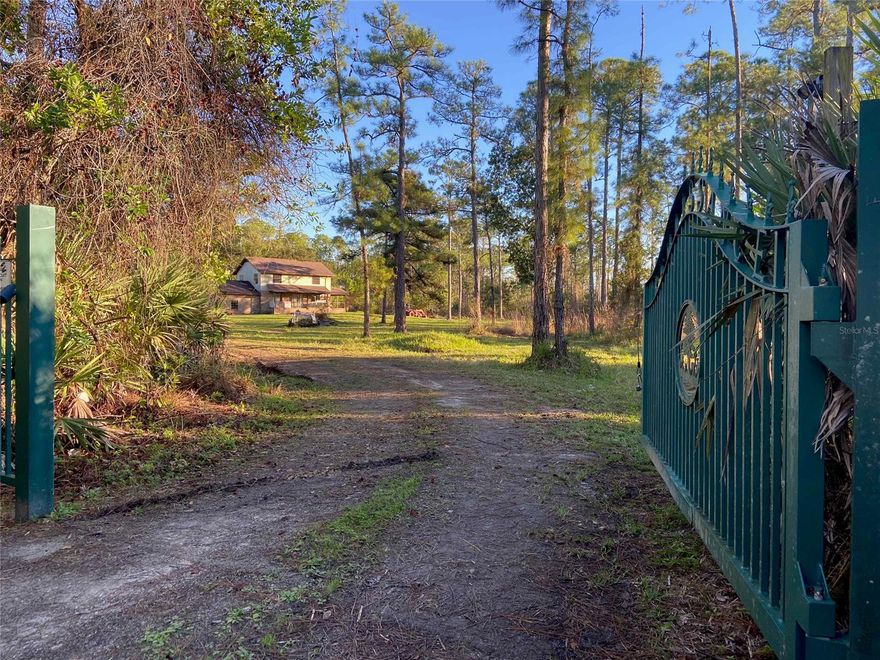 Beautiful brick 3 bedroom 2.5 bath with living room, family room, eat-in country kitchen, 2 car garage, screen porch, 20x40 barn on 10 acres. Very private with gated entrance. Needs a little TLC. Has beautiful lake and mature trees.