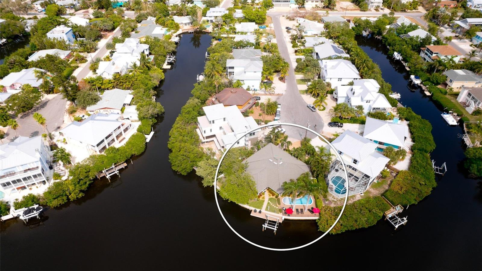 EXTRAORDINARY waterfront views, you have to see to believe!! Nestled on a quiet cul-da-sac, on Anna Maria Island’s coveted North End, this custom-built turnkey furnished, 3 bedroom, 2 bath home has a 118’ curved waterfront seawall offering panoramic views of one of the widest open water canals on the island. Property sits on a 9,147 square foot lot, giving you plenty of space, privacy and tranquility. A grand entry opens to an expansive living area with vaulted ceilings, skylights and tiled flooring throughout. The open concept kitchen is adjacent to the dining area providing seamless flow between the kitchen and living room, making it ideal for entertaining. The master suite is a private oasis, offering a walk- in closet, and en-suite. The two additional bedrooms are equally spacious and well-appointed, providing comfort and convenience for family members and guests along with phenomenal storage that can be used as an Owner’s Lock-up.
The true highlight of this home is the outdoor living space. Full-length glass sliders at the back of the home lead to a screened lanai where you can experience true coastal living - feel the tropical breezes, listen to ocean waves and spot manatees from this favorite indoor/outdoor space. Step out to the massive pool deck with private spa and newly remodeled pool. The back yard is beautifully landscaped with gorgeous mature trees adding to the privacy and serenity of the property. Take in sunsets or fish from the private dock, which also includes a10,000lb. boat lift. Just a short distance from the Islands pristine beaches, charming shops, and renowned restaurants. This home is a perfect island investment with impressive rental income and as a private retreat for making memories with your family. This gorgeous home and property are a dream come true for those seeking the ultimate coastal living experience!