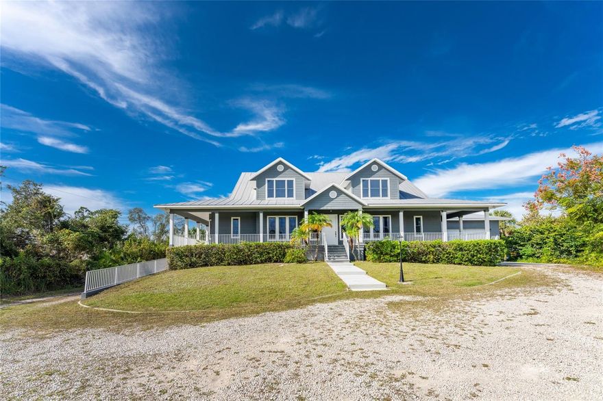 Experience a beautiful blend of old Florida charm and waterfront luxury at this 2002-BUILT, CUSTOM HOME ON 2.5 ACRES. Designed with three stories, the home has more than enough space for you, your family and all of your toys! A WRAP AROUND PORCH and front steps leads you through the entrance into the main living level to welcome you with an impressive foyer and introduction to the incredible woodwork displayed throughout this home. A STUDY/DEN is situated off the foyer with glass French doors and a wet bar – perfect for the at home work space with convenient access to the GENEROUS PRIMARY BEDROOM. This bedroom is the only one on the main living level giving privacy and quiet to the owners along with an incredible view to the outdoors through multiple windows, access to the porch, two walk-in closets and an ensuite bath complete with a walk-in shower, two vanities and stand-alone, cast-iron tub. Entertaining is easy with the OVERSIZED KITCHEN that flows seamlessly into the FORMAL DINING ROOM and living room with a BREAKFAST BAR ISLAND and DINING NOOK for seating. All this centered around the ENCHANTING TWO-SIDED, GAS FIREPLACE for added ambiance and warmth. Thoughtfully designed off the kitchen is a HALF BATHROOM for guests and SPACIOUS LAUNDRY ROOM offering even more storage and a BUILT-IN DESK for a family command center or hobby area. This side of the home also offer access to the EXPANSIVE BACK PORCH and garage access to the OVERSIZED TWO CAR GARAGE WITH EXTRA TALL DOOR for a small RV or boat with tower. Up the wooden stairs to the THIRD LEVEL, you’ll find THREE LARGE BEDROOMS and an ADDITIONAL BATHROOM along with plenty of storage and versatility. Meanwhile, the ENTIRE BOTTOM FLOOR, accessed through a set of stairs from the main level, leads you into the DOWNSTAIRS GARAGE with all the space you could dream of for more cars, toys, fishing gear, a game room – you name it! With three sets of glass doors, you can step outside to your EXPANSIVE BACKYARD and take in all the possibilities of customizing this home to fit your family needs. Tucked on a small cove off GOTTFRIED CREEK – this is the PERFECT, PRIVATE WATERFRONT OASIS for backwater fishing, kayaking, paddleboarding or just relaxing on the dock, taking in the sights. Down the creek and under one bridge will lead you into Lemon Bay with ACCESS TO THE GULF OF MEXICO, sandbars and white sand beaches of the west coast! Have peace of mind in this home knowing that its ELEVATED and BUILT WITH HARDY PLANK SIDING, a METAL ROOF and comes with a HOME WARRANTY!