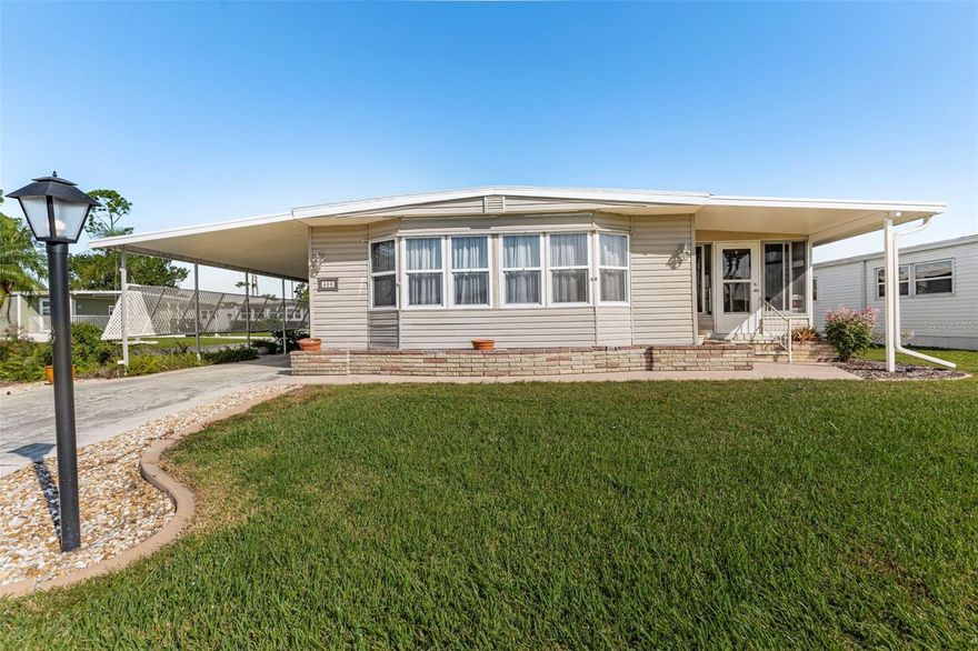 This lovely, spacious home is situated on a tranquil La Casa lot. It features an entryway with two double storage closets. The kitchen includes a breakfast bar, double pantry, newer soft-close cabinets and drawers, granite countertops, a tile backsplash, and stainless steel appliances. Adjacent to the kitchen is a family room that has a sliding door leading to a 10' x 28' acrylic-enclosed, tiled Florida room, which also has a door to the rear patio area. The living room is brightened by six windows and features another sliding door to the Florida room. The dining room includes a built-in hutch, perfect for displaying your crystal, China, and collectibles. The primary bedroom offers a dressing area with shelves, a double closet, a walk-in closet, and a pocket door that leads to the primary bath. The bathroom is equipped with a vanity, linen shelves, a storage cabinet, and a walk-in shower. The guest bedroom features two double closets and has access to the guest bathroom, which includes a vanity and a tub/shower combination. Additional features of the home include newer windows, a new membrane roof installed in 2024, air conditioning, and a humidistat. A long carport, complete with a privacy panel, leads to an expanded utility room that contains an additional refrigerator, washer, dryer, work bench and water softener. La Casa boasts 974 home sites nestled among a variety of native trees with spacious common grounds surrounding our eight lakes. We are convenient for shopping, sightseeing, golfing, fishing, and boating, as well as all the culture and elegance the Southwest Florida area has to offer. Residents and visitors enjoy the warmth of Southwest Florida winters in a relaxed and unhurried environment far removed from the hustle of Florida’s east coast. You’ll be surrounded by hundreds of palms reaching for the sky and beautiful mature lush landscaping which demonstrates the utmost level of care our property receives from residents and management. Wireless Internet (Wi-Fi) is available at the Clubhouse, Activity Building, and Recreation Hall area where our pools & spas are located, so you can catch some rays while you catch up on your email! Sound enticing? La Casa is a friendly, family community. You will be away from the hustle and bustle except when you want to be part of it. When you leave our gates, North Port is only 1.5 miles from the city center, where you will find every kind of retail store and service you could need. Come for a visit to this self-contained oasis and see for yourself why La Casa is the ultimate destination for both snowbirds and year-round.