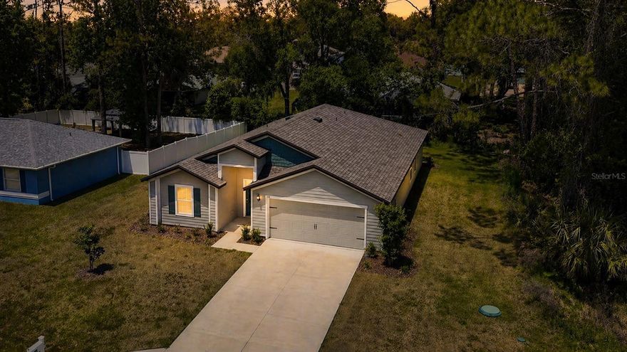 Welcome to this beautifully crafted new-construction home by LGI Homes, ideally located in the heart of Palm Coast, FL. This sought-after Hillcrest floor plan offers 4 spacious bedrooms, 2 full bathrooms, and a 2-car garage. The homesite is uniquely positioned beside and behind city-owned property, providing an exceptional sense of privacy rarely found. Step inside to a grand foyer with soaring ceilings that set the tone for the bright, open layout. The oversized dining room is ideal for hosting gatherings, while the stunning open-concept kitchen features granite countertops and seamlessly flows into the expansive family room, creating the perfect space for everyday living. Luxury vinyl plank flooring enhances the main living areas with both style and durability. Enjoy Florida living at its finest on the large, covered patio—your own peaceful retreat for morning coffee or evening relaxation. The primary suite is a true sanctuary, offering a generous walk-in closet and a spa-inspired bathroom complete with quartz countertops, a relaxing soaking tub, a walk-in shower, and a dual-sink vanity. Located just 9 miles from Flagler Beach, you’re only a short drive from sun, sand, and surf. With convenient access to both Palm Coast Parkway and SR 100, you’ll enjoy an abundance of nearby shopping, dining, and everyday conveniences. Ask about special incentives with the preferred lender, and make this beautiful new home yours!