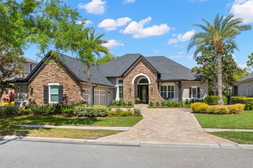 One or more photo(s) has been virtually staged. Step into refined elegance as you arrive via a stately brick-paved driveway leading to a side-entry three-car garage, which includes an electric car charger and a newly redone floor - an immediate indication of the home’s thoughtful design and upscale appeal. A charming brick front porch welcomes you, complemented by a glass-paneled entry door flanked by dual sidelights, offering a warm and sophisticated first impression. Inside, the home unfolds with stunning engineered  hardwood  flooring spanning the entire first level. To the left, a gracious living room showcases crown molding and timeless detailing, while to the right, a formal dining room exudes elegance with upgraded lighting and architectural accents. Throughout the home, you’ll find elevated finishes including plantation shutters, upgraded windows, designer light fixtures, and beautifully paneled doorways. The owner’s suite is a true retreat—generously sized with a private sitting area and adorned with crown molding. The fully renovated spa-inspired bathroom features quartz countertops, a luxurious step-in shower and soaking tub area, a private water closet, and expansive California Closets with custom built-ins. At the heart of the home, the chef’s kitchen has been tastefully refurbished to combine beauty and functionality. Highlights include a large center island, wine refrigerator, ample pantry space, wall oven and microwave, and a GE Profile gas cooktop with five burners—perfect for both everyday living and entertaining, wonderfully updated quartz countertops and wonderful back splash; Upstairs, a spacious bonus room offers flexibility for leisure or work, enhanced by updated baseboards and abundant natural light, upstairs also boasts a bedroom and full bath; Downstairs Bedrooms are thoughtfully designed and include closets with built-in features, and bathrooms have been fully updated with high-end finishes, including double vanities and oversized showers. A dedicated office nook between offers custom built-ins providing the ideal homework or productivity space. Additional features include a well-equipped laundry room with built-in storage, washer and dryer stay and you have direct garage access. Even the under-stair space is optimized with custom storage solutions, while every closet throughout the home boasts built-in organization. Outdoors, a private, fully fenced backyard creates a serene oasis. The brick-paved pool and spa area is designed for relaxation and entertaining, complete with a built-in fire pit, floating seating, and a beautifully appointed outdoor kitchen. A wood-accented ceiling adds warmth and character, making this the perfect setting to unwind or host unforgettable evenings. This exceptional residence seamlessly blends luxury, comfort, and thoughtful craftsmanship—an elevated living experience in every detail. You will love this 5 bedroom plus bonus plus office niche home with over 4200 sf of gracious living space. Additional things to note: New Roof in 2021, Front & Back new Hurricane Windows 2024; Enjoy the beautiful lush landscaping including landscape lighting that illuminates the home's landscape in the evenings. Great attention to details abounds in this home.