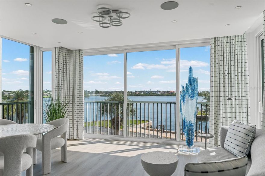 Discover this truly exceptional 3-bedroom, 3-bathroom condominium offering mesmerizing views of the Intracoastal Waterway. Redesigned with modern elegance, this home features a spacious chef's kitchen equipped with Sub Zero, Monogram, and Viking appliances, along with an impressive six-foot-tall built-in double-door wine cellar. This stunning residence boasts 9-foot ceilings, copious custom built-ins, and spa-worthy bathrooms. Beautiful plank tile flooring extends across the 2,500 square feet of living space. Impact-resistant windows and sliding doors were installed in 2025 along with custom light filtering and room darkening electric shades for maximum comfort and peace of mind. The expansive light-filled lanai has been thoughtfully converted into year-round living space, including air conditioning, cabinetry and a new ceiling with recessed lighting and in-home theater speakers. The HVAC system was replaced in 2020 and the water heater in 2021. A private one-car garage is conveniently situated under the building. Dolphin Bay offers an updated clubhouse, fitness center, premium Hartru/clay tennis courts, a day dock for boating and fishing, as well as a pool and spa. This lively, pet-friendly community is home to just 50 owners. Enjoy easy access to the beach and village via trolley, where you can explore shopping, live entertainment, and diverse dining options. Experience unparalleled sophistication and comfort in this exquisite residence. Luxury looks like home at Dolphin Bay.
