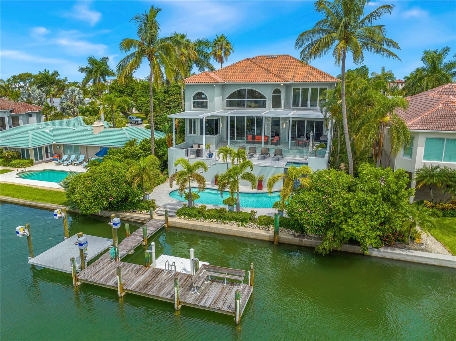 Welcome to your dream home - a sun-kissed sanctuary with attention to detail and overflowing with class. This dramatic waterfront residence graces a lushly landscaped lot on coveted Lido Key, just a block away from the pristine shores of Lido Beach and a few blocks from the vibrant shops and restaurants of St. Armands Circle.
Step inside this one-of-a-kind custom floorplan that spans across three luxurious floors, offering four bedrooms and four and a half bathrooms. From the moment you enter, you'll be captivated by the abundance of natural light that spills through every window, enhancing the granite, marble, and tile finishes throughout.
The heart of the home is the gourmet kitchen, with updated kitchen cabinetry featuring granite countertops and a gas hob, perfect for culinary enthusiasts. With a living room boasting a coral stone gas fireplace, a dining room, family room, and an office, this home offers an ideal space for every aspect of your lifestyle.
The master suite is an oasis of tranquility with stunning views of the water and access to a balcony that allows you to soak in the breathtaking surroundings. Pamper yourself with not one, but two bathrooms in the master, along with a garden tub and a huge double walk-in closet for him and her.
For utmost convenience, an elevator connects all floors, making movement effortless. And with all rooms being ensuite, privacy and comfort are paramount for all occupants.
Entertaining is a delight in this home, as it boasts a great entertainment space and stunning vistas that provide the perfect backdrop for gatherings. Whether it's indoors or outdoors, this residence has been designed to bring friends and loved ones together in grand style and doesnt get any better to take in those magnificent sunsets on the water.
But that's not all - Step outside on to the terrace and your greeted with pure a glass balcony with an adjustable aluminum sunbrella that will allow you to adust at the touch of a button how much sun you desire with that morning cup of coffee. Embrace the ultimate Florida lifestyle with an oversized hot tub that waterfalls into the heated salt water pool below, ideal for year-round enjoyment. If you're an outdoor enthusiast, take advantage of the new kayak launch just installed and explore the deep sailboat water that leads to Sarasota Bay, promising endless aquatic adventures. Theres plenty of room to moor your cabin cruiser and jetskis.
This waterfront gem is not just a house; it's a home where luxury and location meet, offering the best of both worlds. With a fabulous deep water dock, boating enthusiasts will be thrilled to be just two minutes away from the Gulf by boat.
Immerse yourself in the unparalleled beauty and elegance of this extraordinary property. With its mesmerizing views, top-of-the-line amenities, and thoughtfully designed living spaces, this is truly the best place to live, work, and play and if you are a car enthusiast then youll love the double entry garage under the house which will park 6 cars. the 3000 sq.ft. lower level (with potential for many more, storage room and work out/ rec room.
Don't miss the opportunity to experience the epitome of Florida living – your own private paradise awaits!
