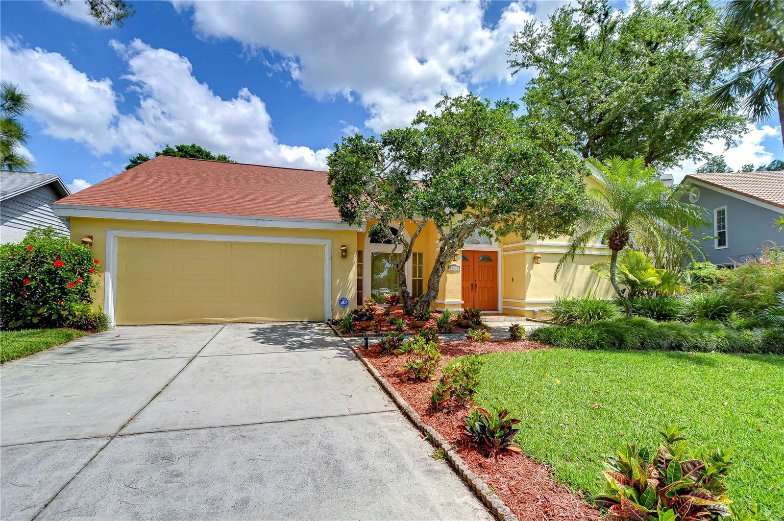NEW PICTURES** Discover an exceptional gem in the heart of Carrollwood Village, nestled within the tranquil community of Stonegate. A picturesque landscape and meticulously manicured lawn welcome you home, leading to elegant double front doors that make a striking first impression. Step inside to soaring vaulted ceilings and travertine floors that flow throughout the main living areas. NEW A/C 1 Year! NEW Roof 2 Years! This stunning single-story pool home offers 2,850 square feet of thoughtfully designed living space. It features 4 spacious bedrooms, 2.5 bathrooms, and a 2-car garage, plus an additional outdoor pool shower and bath—perfectly crafted for both comfort and functionality. Beyond the foyer, the spacious dining and living rooms boast soaring ceilings and flow seamlessly into the stunning gourmet kitchen (Just Painted). A double doorway opening off the living room opens into a versatile bonus room, perfect for a playroom, or additional living space. Elegantly finished with Venetian plaster, the kitchen has rich wood cabinets with crown molding. Granite countertops and a classic tile backsplash enhance the kitchen’s charm, while the layout wraps around to reveal a built-in desk area and a pantry with pull-out shelving for optimal organization. At the heart of the kitchen is a 12 foot center island with a breakfast bar, crowned by a hanging pot rack. A full suite of appliances and a cozy café area—with sliding glass doors to the bonus room—complete this well-appointed space. Adjacent to the kitchen, the family room invites comfort with its wood-burning fireplace—set on a travertine platform and framed by a dramatic stone surround that rises to the ceiling—complemented by abundant built-in bookcases. Double doors off the foyer open to the spacious primary suite, which features a sitting area, a doorway to the bonus room and a luxurious ensuite bath. The bath features dual vanities with granite countertops and undermount sinks, a built-in linen tower, a double-size tiled walk-in shower, a private water closet, and a California Organized walk-in closet. The bonus room provides access to the oversized screened lanai and pool deck—perfect for relaxing or entertaining. Take a dip in the expansive chlorinated pool and enjoy tranquil bass filled pond views. The backyard is lined with mature trees and 15’ hedges for privacy with an open patio area for lounging. The inside laundry room offers convenience with a base cabinet, utility sink, and washer/dryer hookups. Additional features include a RING doorbell, NEST thermostat, a Rheem WiFi-enabled water heater (new in 2021), and a water softener—all enhancing comfort and efficiency throughout the home. Carrollwood Village offers an exceptional lifestyle with a wide array of amenities, beautifully landscaped common areas, sidewalks, and reclaimed water. Residents enjoy a strong sense of community supported by a Cultural Center and a vibrant calendar of events throughout the year. The 21-acre Carrollwood Village Park includes adult challenge courses, scenic walking/jogging trails, a splash pad, boardwalk, dog park, fishing pier, soccer fields, cooling fountains, tennis and pickleball courts, skate track, and arboretum—offering something for everyone. Don’t miss the opportunity to make this beautiful home yours in the heart of the centrally located, amenity-rich community of Carrollwood Village.