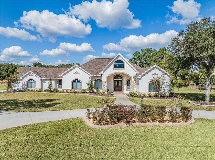 One or more photo(s) has been virtually staged. Welcome to this exquisite 4-bedroom, 3.5-bathroom home in Lutz, Florida, a true masterpiece of comfort and luxury set on a sprawling 1.30-acre conservation lot. This property boasts an impressive array of features, making it an ideal haven for both relaxation and entertainment. Inside, the residence continues to impress with a stone-upgraded elevation, new roof, and a massive covered front porch and decorative glass double doors. The house is adorned with tray and coffered ceilings, crown molding, and high baseboards, adding to its elegance. The spacious kitchen is a chef’s delight, featuring stainless steel appliances, an island with an additional sink and a wine refrigerator, double oven, breakfast bar, under-mount cabinet lighting, tile backsplash, a walk-in pantry, all topped off with granite countertops. Additional luxuries include a large living room, a cozy bonus room, an office, and a den, providing ample space for work or leisure. The primary bedroom is an ultimate retreat with back patio access, a giant walk-in closet with built-in shelving and drawers, and a full bathroom with his and hers sinks, a luxurious garden tub, built-in vanity desk, a walk-in glass shower with multiple shower heads, and a wet closet for additional privacy. The custom-built entertainment center and built-in surround sound system throughout the house elevate your living experience. The laundry room is a model of convenience with cabinets, a utility sink, an ironing board, clothing racks, and a mudroom. The home is enhanced with practical amenities like video doorbell, security floodlights, 4 new mini AC splits, double pane windows, and custom concrete landscape curbing amidst mature oak trees. All this comes with the freedom of NO HOA, offering unparalleled flexibility in this serene Lutz neighborhood. The heart of this home is the stunning outdoor area, complete with a heated, auto-cleaning inground gunite pool and hot tub, surrounded by a covered and screened-in back patio. This outdoor oasis is fully equipped for entertainment with a fireplace, outdoor kitchen featuring a grill, sink, refrigerator, ice maker, bar, granite countertops, as well as fans, speakers, and is cable-ready. For sports enthusiasts, the private full-sized basketball court is a dream come true. Upgrades: new well pump 2023, new pool/spa heater 2023, new dishwasher 2022, new kitchen fridge 2022, new water softener 2023, new on demand water heater 2023, upgraded insulation in attic to r-38, new pool pump 2023, new washer and dryer 2022, new paint interior and exterior 2023, new roof 9/2023, whole house speaker system 2022, upgraded primary closet 2022, new LED lights entire house 2023, pavers re-sealed 11/23. This property is more than a home; it's a lifestyle, offering everything you could wish for in a luxurious Florida living experience. You do NOT want to miss this opportunity! Schedule your showing today!