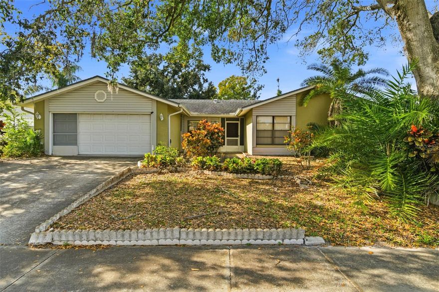 Set on the edge of Carrollwood in sought-after Northdale, this spacious pool home features an open-concept design that lives far larger than its size, offering comfortable everyday living and excellent flow for entertaining. The well-designed floor plan includes a living room, dining room, family room, and primary bedroom, with large sliding glass doors from both the living room and family room opening directly to the screened-in lanai and pool—creating seamless indoor-outdoor entertaining. Ceramic tile runs throughout the entire home, providing a cohesive, low-maintenance living space. The family room is anchored by a wood-burning fireplace and recessed lighting, adding warmth and character while maintaining an open connection to the outdoor living area. The kitchen features raised-panel oak cabinetry and a designated breakfast area, offering functionality and separation from the main living spaces. Multiple living and dining areas allow for flexibility in layout and use. The primary suite serves as a private retreat with a wall of closets, an ensuite bathroom featuring a newly updated shower, and a sliding glass door providing direct access to the screened-in lanai and pool. Additional bedrooms are well-sized and thoughtfully positioned. Outdoor living is a true highlight, featuring a massive in-ground pool, newly screened lanai, expansive pool deck, covered outdoor living area, and a fully fenced yard surrounded by mature landscaping. A side-yard green space adds additional outdoor flexibility, while the large, deep two-car garage provides excellent storage and functionality. Recent updates include a new electric panel,  new HVAC ductwork throughout (just completed), pool equipment (2024), newly updated roof, gutters, hot water tank, and AC, new lanai screening, and an updated primary bathroom shower. With no HOA fees and no CDD fees, this Northdale home is conveniently located near top-rated schools, parks, golf courses, shopping, dining, Whole Foods, Sam’s Club, the YMCA, and the Dale Mabry corridor. Enjoy easy access to the Veterans Expressway, approximately 20 minutes to Tampa International Airport and 25 minutes to Downtown Tampa. Schedule your private showing today and experience all this Northdale pool home has to offer.