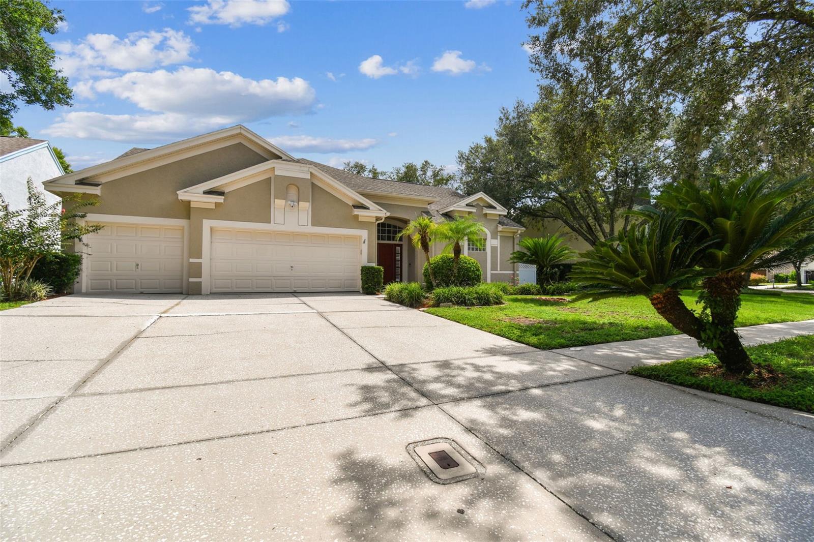 An extraordinary opportunity to own a rare piece of TAMPA PALMS real estate! This beautifully renovated home situated on a .32 acre waterfront lot offers 2,318 sq. ft. of luxurious living space, featuring 4 bedrooms, 3 baths, and a spacious 3-car garage with soaring 15+ ft ceilings throughout much of the home. No detail has been overlooked in this meticulously crafted property. A long list of recent high-end upgrades includes a new kitchen(2022), luxury vinyl plank flooring (2023), quartz countertops (2023) exterior paint (2020), HVAC system (2020), roof (2018) and much more! The heart of the home is the elegant, open-concept kitchen and living area, which seamlessly connects to the massive fenced in yard with beautiful views of the water—offering the perfect setting for relaxed indoor-outdoor living! The primary suite is a true retreat with vaulted ceilings, walk-in closet, remodeled bath and private access to the lanai with beautiful views of the water! Located within the prestigious community of Wellington at TAMPA PALMS, residents enjoy an impressive array of amenities including lighted tennis, pickleball, basketball, ball fields, multiple playgrounds, jogging trails and access to the Tampa Palms Golf and Country Club where the family will find a world-class Arthur Hills Designed golf course, exceptional amenities and a robust social calendar! The club even offers a 25-suite boutique luxury hotel for overnight stays and out-of-town guests! Convenient to top-rated schools, I-75, Wiregrass, Tampa Premium Outlets, hospitals, and dining, this home truly offers the ultimate Florida lifestyle in one of Tampa’s most sought-after communities!