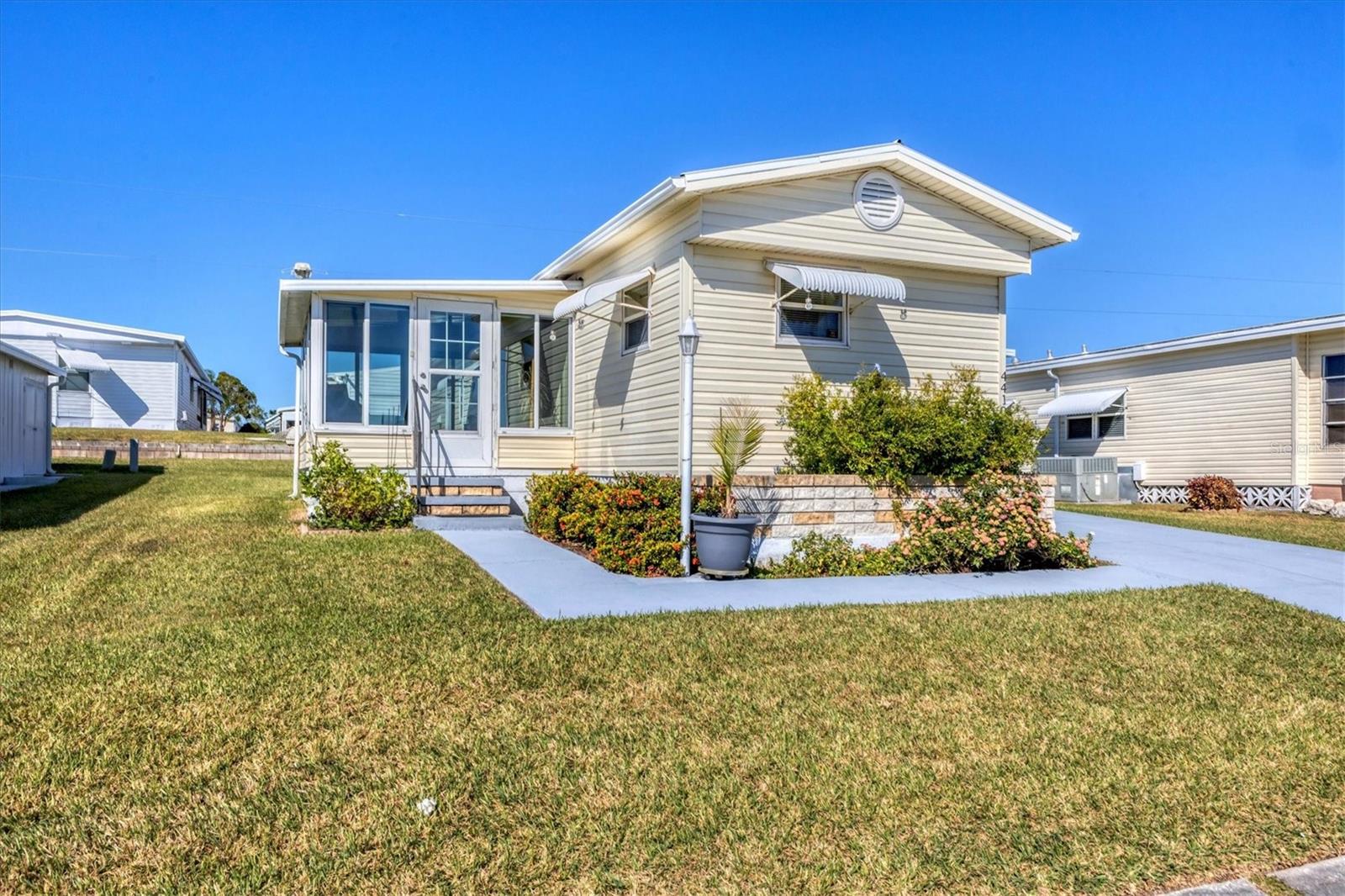 Welcome to this beautifully updated home in the desirable 55+ Land Owned community of Tidevue Estates! This residence features a split bedroom plan with new floors and subfloors throughout. The kitchen has an island with storage, a French door refrigerator with an ice maker, grey cabinetry, a vintage tin backsplash, faux Corian countertops, a self-cleaning 6-burner range, and a deep farm sink. The open floor plan is perfect for entertaining family and friends. Enjoy the waterproof luxury vinyl flooring that extends throughout the home. The primary bedroom includes a built-in desk and two closets. The primary bathroom features a bath fitter walk-in shower with glass doors and an updated vanity. The second bedroom offers its own half bath for added convenience. Relax in the Florida room, equipped with a mini-split AC system, custom blinds, and updated windows. The AC unit is only 2 years old, ensuring efficient cooling. Additional features include an indoor washer and dryer, a paver patio perfect for sunbathing with a roll-out cover, and a carport for an outdoor living space. The home also includes an easy-access ramp with a wood deck, a two-car carport, and native Florida landscaping surrounding the property. Low HOA of only $600 annually. Pets are not permitted. Plenty of activities to keep you busy in this community. Take a water aerobics class in the solar-heated community pool or work on your tan. The community library has free WI-FI connection. Updated fitness center. Meet friends and make new ones for a game of indoor pickleball, bocce ball, or shuffleboard. Join the Golf League. Take a bike or golf cart ride to Veteran's Park to watch the wildlife and sunset. Ellenton Premium Outlet Mall, restaurants, and medical facilities are just minutes away. Easy access to I-75. Not to mention a short drive to our beautiful Gulf Beaches. Don't miss the opportunity to own this charming and modern home in Tidevue Estates!