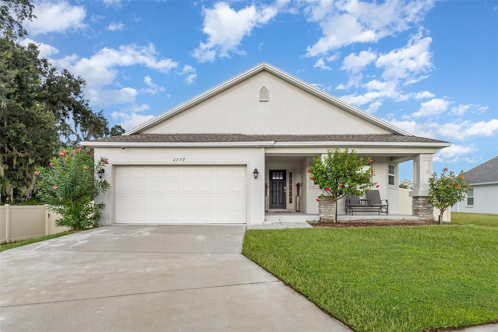 Located in the gated community of Linden Trace in Lakeland, Florida, this 4-bedroom, 3-bathroom home was built in 2022 by Southern Homes and offers 2,042 sq. ft. of living space on an oversized lot.
The open floor plan includes vaulted ceilings, luxury vinyl plank flooring, gray-tone walls, and a kitchen with quartz countertops and Samsung stainless steel appliances. The living room features recessed lighting and French doors leading to a screened porch and fenced backyard.
The home has two primary suites, each with a walk-in closet and full bath. The main primary suite features tray ceilings, crown molding, dual sinks, a center vanity, and marble-design finishes. The third bedroom includes a walk-in closet, and the fourth has a built-in closet. An additional full bath with tub/shower serves guests.
Additional features include an interior laundry room, attic with drop-down ladder and added wood flooring for storage, water softener installed January 2024, and an AC UV light system. The property backs to a nature preserve along the left and rear for added privacy.