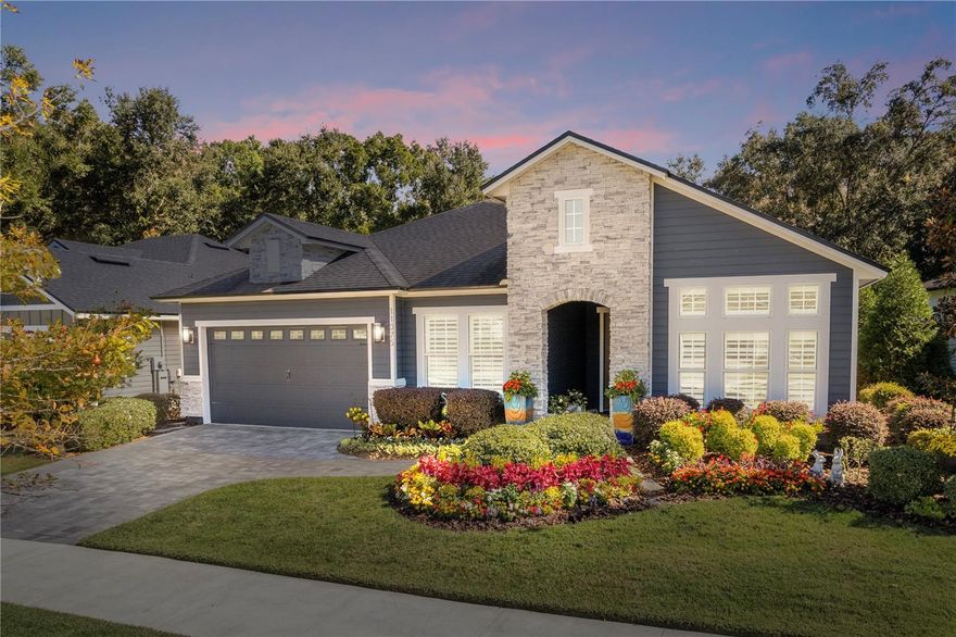 Welcome to an exceptional 5 bedroom, 3 full bath home in the heart of Oakmont, one of Southwest Gainesville’s most sought-after communities, where refined design meets peaceful privacy. From the moment you step inside, you’ll notice the attention to detail—porcelain tile laid on the diagonal creates a bright, flowing feel, complemented by soaring 10’ and 11’ ceilings, extensive crown molding, and custom ceiling details that elevate the formal living spaces. The home is beautifully appointed with engineered white oak flooring in all bedrooms, no carpet or LVP throughout, and thoughtfully selected lighting that highlights every room.

The kitchen is both stunning and functional, featuring premium cabinetry with glass display uppers accented by LED lighting, a dramatic tumbled marble backsplash extended to the ceiling, luxurious countertops, a low-profile microwave, and a paintable, trim-wrapped island that anchors the open-concept living area. Quartz countertops and framed mirrors continue the upscale finishes throughout all bathrooms, along with upgraded glass shower enclosures. Plantation shutters, custom fixtures, LED lighting throughout, and a well-designed laundry room with cabinetry and sink add both style and convenience.

Designed for effortless indoor-outdoor living, the extended covered lanai opens to a private backyard that backs to a dedicated treed conservation area, offering a serene, wooded backdrop. Extensive exterior stone accents, upgraded landscaping around the entire home, paver driveway and walkways, exterior LED night lighting, and a quiet, well-insulated interior further enhance the home’s comfort and curb appeal.

Oakmont offers more than just a beautiful home—it delivers a true lifestyle. Residents enjoy a resort-style Residents’ Club with a spectacular pool and splash pad, fitness center, tennis and basketball courts, walking trails, and vibrant community events throughout the year. Conveniently located with quick access to I-75, Haile Village, Butler Plaza, the University of Florida, and Shands Hospital, this home offers the perfect blend of privacy, luxury, and connectivity.

If you’ve been searching for a thoughtfully upgraded five-bedroom home in a quiet, private setting with all the benefits of resort-style living, this is the one. Schedule your private showing today.