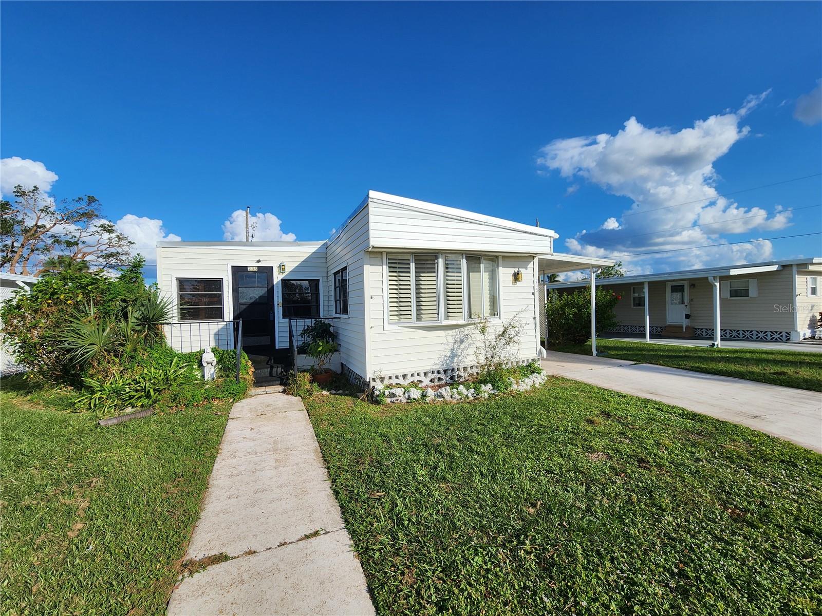 This is the one! *Indulge in the amenities of Windward Isle, where your purchase grants you access to an exercise room, community pool, rec center, and more*Your investment covers grounds maintenance and water expenses*As a property owner, you also become a stakeholder in a corporation that generates revenue from a nearby motorhome park, renowned for its excellent reviews and the most competitive fees for owners*For your convenience, all of the furnishings in the property can convey*Immerse yourself in the tranquil ambiance of this truly pleasant 55+ community—an exclusive location offering serenity and peace*