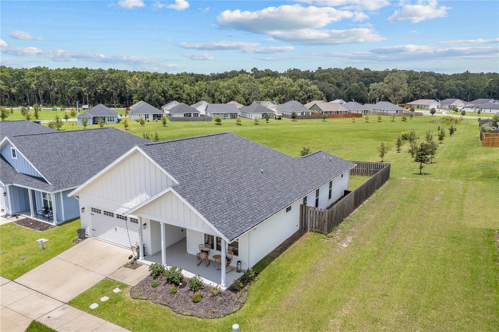This fully custom 3-bedroom, 2-bath home in Savannah Station is a stunning example of craftsmanship and style. It feels brand new and is packed with thoughtful upgrades throughout. Set on a quiet street and backing up to an undeveloped open area, the home offers added privacy and peaceful views with no rear neighbors.
Inside, the open-concept layout features luxury vinyl plank flooring, elegant tray ceilings, and designer fixtures that create a warm, upscale feel. The kitchen is a true highlight with granite countertops, a large island with bar seating, soft-close cabinetry, stainless steel appliances, and a custom walk-in pantry with wood shelving that adds charm and functionality.
The owner’s suite is a spacious and relaxing retreat with a tray ceiling, walk-in closet, and a beautifully finished ensuite bath featuring dual vanities, granite counters, and a fully tiled walk-in shower. The split floorplan provides privacy with two additional bedrooms and a stylish full guest bath on the opposite side of the home.
Enjoy the outdoors from the covered lanai overlooking a fully fenced backyard—perfect for entertaining, relaxing, or letting pets roam. A dedicated laundry room with built-in cabinetry and a whole-home water softener system round out the features.
Located in Savannah Station, just a short drive to Gainesville and High Springs, the neighborhood features sidewalks, streetlights, and tranquil surroundings. Best of all, this home is just footsteps from the brand new community pool + clubhouse currently under construction and playground—offering even more value to this like-new home.