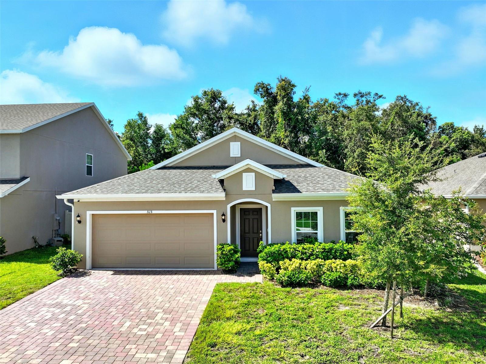 One or more photo(s) has been virtually staged. WELCOME HOME to your 2 years new home! No need to wait to build. This home 4 bedroom, 2 bath home has everything you need as well as an awesome floor plan with a 3 way split! This home features a large formal living area in the front of the house. The hallways are wide and the living areas large. There are 2 bedrooms that share a full bathroom with double sinks and a door to close off the shower/toilet area for busy families. The primary bedroom features an ensuite with 2 sinks, a separate water closet for the toilet, a large soaking tub and a huge shower with rain shower head and Kohler digital controls. The walk in closet is perfect! If you love to cook and entertain, you'll be in heaven. The counter space is endless, the built in double ovens are wonderful and the cabinets are abundant! There is a nice size dinette area that all over looks the large family room. This is a perfect entertaining space. The covered patio and fenced back yard and private and serene. From the quiet, smaller neighborhood to the fenced back yard and wooded view, you'll love this home which sits closer to Mt. Dora while still sitting in Eustis.