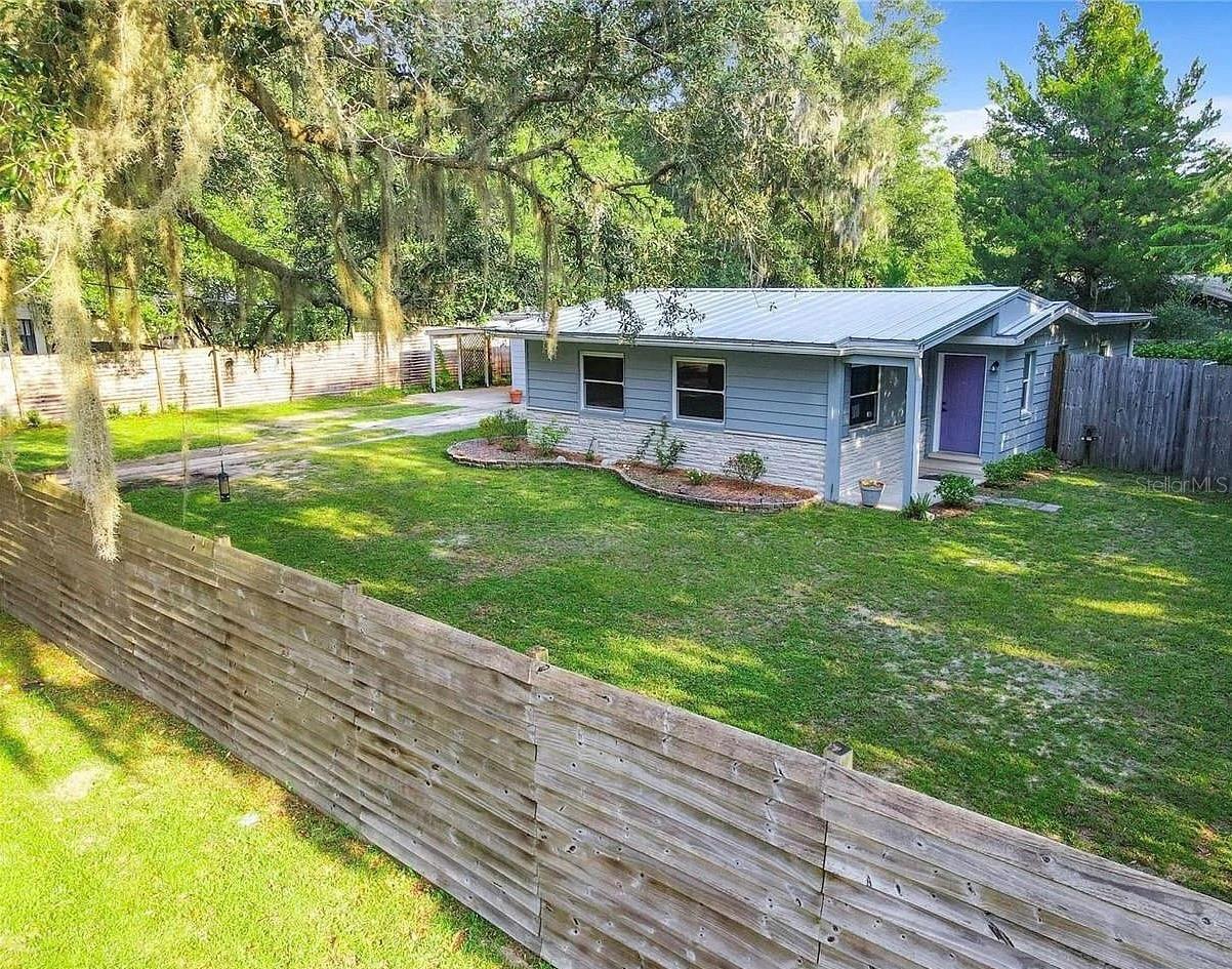 This charming single-family home in Gainesville, FL was newly updated and offers 3 bedrooms, 2 bathrooms and 1,532 square feet of finished living space. Plus 300 square feet of screened porch. Everything is new, heat pump / AC unit. water heater, gas stove, refrigerator, dishwasher, washer and dryer. New roof in 2020. In ground irrigation for front of house and the sides of the home, with timers. Front hedge is also on a timer. Situated on a spacious lot spanning 13,701 square feet, this property is perfect for enjoying outdoor activities and entertaining guests. Fully fenced in yard, enjoy complete privacy, while your pets are able to fully roam around free. Sliding wooden gated enterance. Covered carport with tinted transparent roof. This carport is an extension of the the screen porch. With its classic design and ample space, this home provides a comfortable and inviting atmosphere for residents to enjoy.