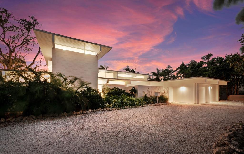 Renowned architect, William Rupp, created this gem in 1965 as one of the newer, mid-century modern style homes in Sarasota's iconic Lido Shores neighborhood. Recently added to the National Register of Historic Places, this home showcases the Sarasota School of Architecture's affinity for open floor plans, an abundance of windows, and indoor-outdoor living. While preserving the original features characteristic of the period, including terrazzo floors, exposed concrete block walls, and wood panel ceilings and beams, the current owners recently updated the kitchen and baths in keeping with the modernistic design. It is fabulous! A private courtyard entry welcomes your guests and tropical gardens surround the home with concrete block walls adding privacy and interest to the design. The interior feels even larger than its footprint due to the openness of rooms and walls of windows. The primary bedroom and main rooms of the home overlook the sun kissed backyard and pool which is perfectly fitting for hosting a 1960's Palm Springs, Hollywood celebrity soiree! 4 bedrooms/4 ensuite baths, large kitchen overlooking the living areas, glamourous owner's suite, fireplaces in the great room and upstairs guest suite, well equipped kitchen and laundry room, two car garage. Lido Shores homeowners enjoy private, deeded access to Lido Beach, sidewalk one mile to St. Armands, and easily accessible to Longboat Key and downtown Sarasota restaurants, dining, shopping, and culture.