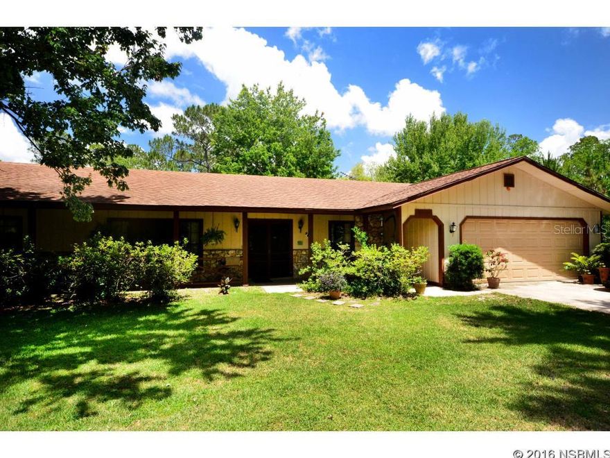 HARD TO FIND spacious and inviting home on 2.5 beautifully groomed acres in a great country location near both New Smyrna Beach and Port Orange. This 2,000+ square feet home features a formal foyer entryway flanked by formal living and dining rooms. A large family room opens up to the kitchen featuring solid wood cabinets, kitchen bar, pantry and tile floors. The split floor plan has large bedrooms with a walk-in master closet and double vanities in both full bathrooms. Oversized 2-car garage also includes a half-bath and laundry room. Large screen porch with tile flooring and tongue & groove wood ceilings make for a perfect place to sit back and relax in a peaceful and private setting. ATTENTION DOG LOVERS: The property is currently set up with a working kennel and has cross fencing for three different pastures including an agility course. The detached kennel is air conditioned and features four separate runs with concrete floors and chain-link fencing both inside and out. It also has a workshop the size of a 2-car garage. The attached garage to the home is currently vented for air conditioning as well with an insulated door. The entire 2.5 acres is fenced and cross fenced and could easily be used for equestrian or agricultural purposes.