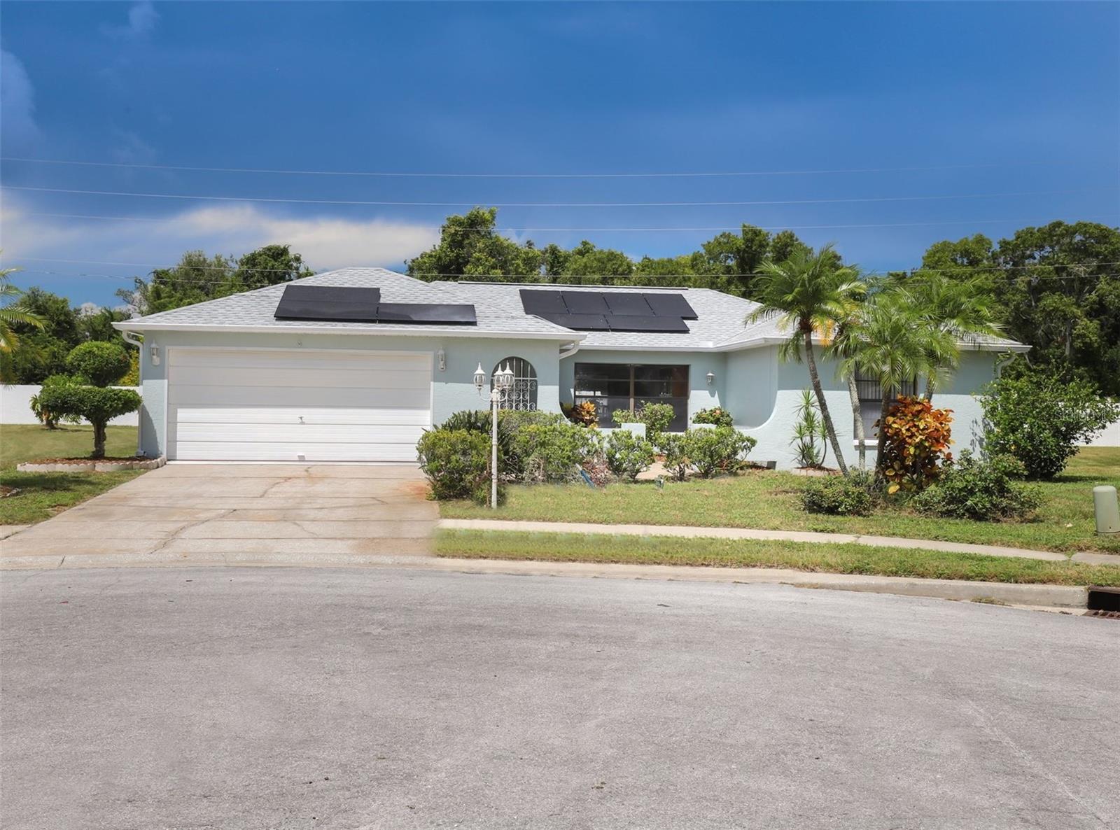 Welcome to this original owner home, nestled at the end of a quiet cul-de-sac on a .27 acre lot with no rear neighbors, offering the perfect blend of privacy and space. Built in 1988 and freshly painted on the interior and exterior, this home is move-in ready. This home combines comfort, space, and flexibility. Step inside to a light and bright interior, featuring two separate living areas, perfect for relaxing or entertaining. The open-concept kitchen is equipped with granite countertops, a breakfast bar and separate eat-in area. Enjoy effortless indoor-outdoor living with three sets of sliding glass doors that lead to an expansive 34x16 covered and screened lanai—the perfect setting for gatherings or serene evenings. The spacious primary suite offers a walk-in closet and an en suite bath, while a second full bathroom serves the additional living areas. Key upgrades include: 3-year-old roof (2022), newer water heater, GE electric panel, private well pump for irrigation and buildable concrete slab under lanai for future addition if desired. Located in a non-flood zone with no HOA, and just minutes to Anclote River Park, where you’ll enjoy access to a public boat ramp, beach, multi-use trail, pavilions, playground and more.