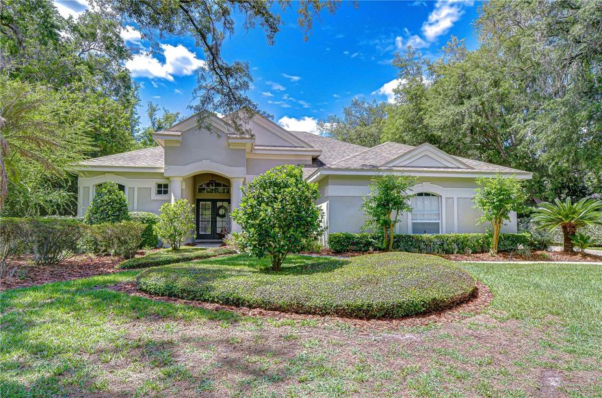 ** ASSUMABLE VA LOAN @2.25%, FOR VA QUALIFIED BUYER** WELCOME TO YOUR PRIVATE PARADISE IN GATED FISHHAWK TRAILS. Tucked beneath a canopy of mature trees on a half-acre homesite, this exceptional executive residence is designed to impress at every turn—offering a rare combination of a triple-split bedroom floor plan, dedicated office, spacious bonus room, and an outdoor retreat straight from the pages of a luxury magazine. Step outside and prepare to be captivated. A 2,200-square-foot lanai unfolds into a true resort-style escape—featuring a sparkling pool, jetted spa, gas firepit, rock waterfall, charming wooden footbridge, and a tranquil koi pond surrounded by lush, tropical landscaping. The expansive travertine deck offers both screened and covered spaces, creating the perfect setting for year-round relaxation and unforgettable entertaining. Inside, the home seamlessly blends indoor and outdoor living. Quadruple pocketing sliders in the family room, along with multiple sets of double sliders from the living room, kitchen, primary suite, and bonus room, invite the outdoors in—transforming the entire home into an entertainer’s dream. The thoughtfully designed layout includes a versatile 300+ square-foot bonus room with dual closets, ideal as a 5th bedroom, private guest or in-law suite, or the ultimate media, fitness, or game room—with convenient access to a full pool bath. At the front of the home, a French-door office sits just off a grand foyer, flanked by elegant formal living and dining spaces. The heart of the home is the chef’s kitchen, beautifully appointed with granite countertops, rich wood cabinetry, tile accents, and top-of-the-line Viking stainless appliances, including double built-in ovens and a gas cooktop—flowing effortlessly into the warm and inviting family room with fireplace. Privately tucked away, the primary suite offers a serene retreat with its own sliders to the lanai, spacious walk-in closets, and a spa-like en-suite bath featuring dual vanities and a walk-in shower. Adding even more peace of mind, this home has been thoughtfully updated and meticulously maintained, including a roof replacement in 2018, water heater (2020), and extensive pool upgrades: pool pump and heater replaced in 2021, pool lights and control panel updated in 2023. Interior improvements include bathroom flooring refreshed in 2023 and a new shower in the pool bath (2023). Additional features include crown molding, wainscoting, custom window treatments, an on-demand water heater, and a well-fed irrigation system. A side-entry 3-car garage with extended parking completes the package. All of this is located within the highly sought-after FishHawk Trails community, offering 24-hour security and access to top-rated schools, parks, trails, recreation, shopping, and vibrant community life.