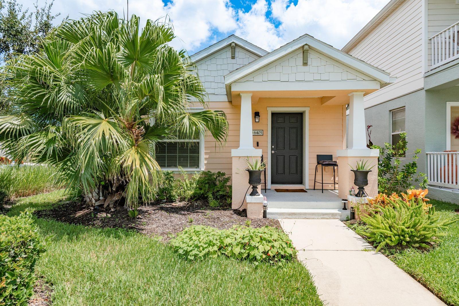 Welcome to 6405 Autumn Woods Way, a beautifully maintained 2-bedroom, 2-bathroom corner-lot home in the highly desirable GATED COMMUNITY of Woodbrook. Built in 2013, this single-story residence offers 1,080 sqft. of thoughtfully designed living space, combining modern finishes with a warm, inviting atmosphere. From the moment you arrive, the charming covered front porch, manicured landscaping, and corner-lot setting create fantastic curb appeal. Step inside to an OPEN-CONCEPT FLOOR PLAN with soaring ceilings, tray accents, and large windows that fill the home with natural light. The spacious living and dining areas flow seamlessly into the kitchen, which features GRANITE COUNTERTOPS, STAINLESS STEEL APPLIANCES, a breakfast bar, SOLID WOOD CABINETRY, and ample storage—ideal for both everyday living and entertaining. The primary suite offers a peaceful retreat with a WALK-IN CLOSET and a private en-suite bath featuring DUAL VANITIES, solid-surface counters, and a spacious walk-in shower. The second bedroom is generously sized and perfect for guests or a home office, with an adjacent full bathroom. Additional highlights include an INTERIOR LAUNDRY AREA with WASHER AND DRYER INCLUDED, ENERGY EFFICIENT WINDOWS, and ceiling fans throughout. Outside, enjoy your morning coffee on the covered front porch or relax in the private rear courtyard. A rear-entry 2-car garage with a paved driveway adds convenience and maintains the home’s attractive streetscape. Residents of Woodbrook enjoy a RESORT-STYLE COMMUNITY POOL, shaded cabanas, a park, playground, and scenic sidewalks—all maintained with low HOA fees and no CDD. This pet-friendly neighborhood is perfectly located just minutes from shopping, dining, I-75, University Town Center, and the beautiful Gulf Coast beaches. This move-in ready home is the perfect combination of comfort, style, and location—ready for you to make it your own!