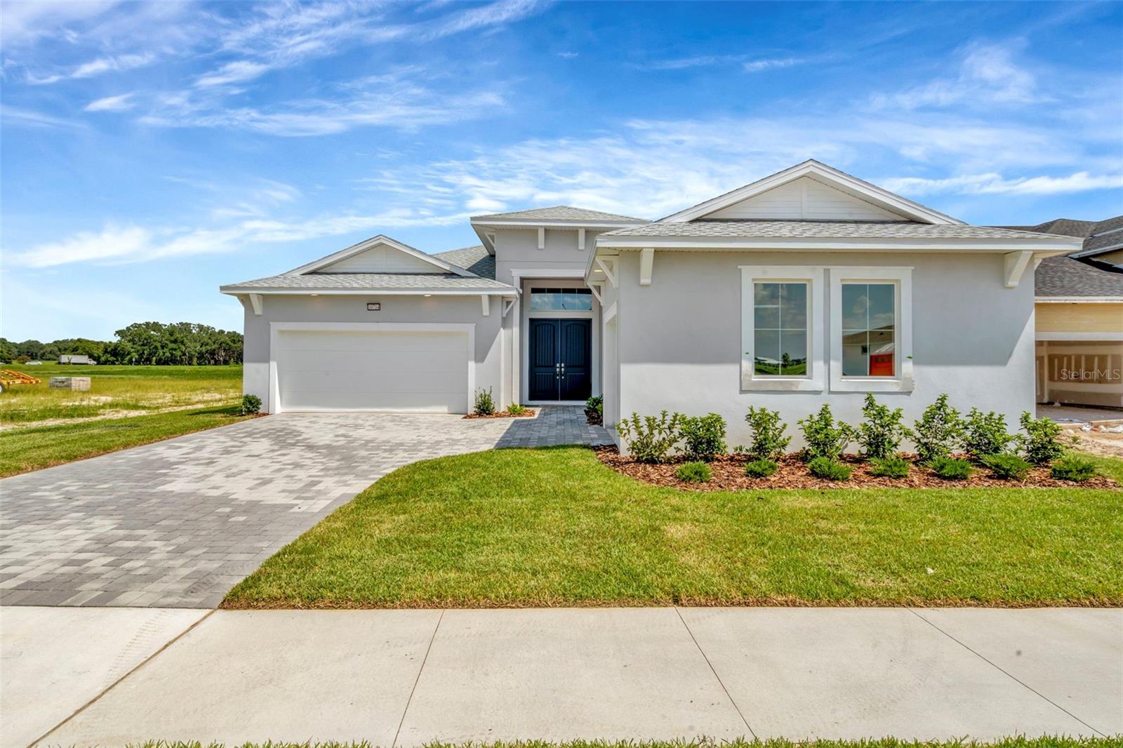 Beautiful 1 Level, 3 Car Garage Home with Open Concept Living and 4 Bedrooms! The Eider plan has the Coastal exterior designs and was built as a single level home. Upon entry you are welcomed to a grand foyer and adjacent wing with 2 secondary bedroom and full bathroom. The well-appointed kitchen offers a corner pantry, large island, and is open to the adjacent dining room and expansive family room that opens to a covered lanai. The primary suite boasts an en suite bath with dual sink vanity, private water closets, huge walk-in closet ad spacious walk in shower.