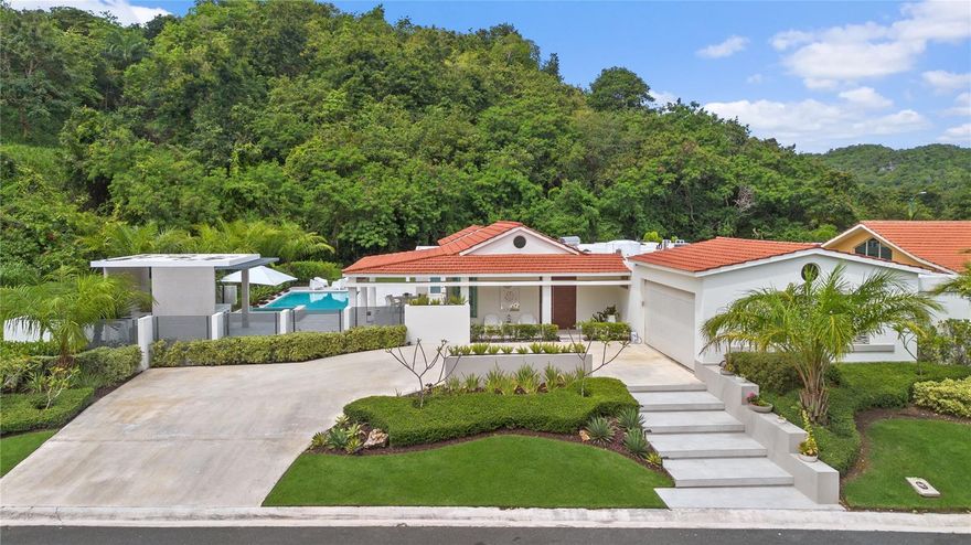 This exceptional single-story residence is situated on a premium corner lot of 1,161 square meters, offering sweeping mountain views and abundant space. With 3,696 sq ft of thoughtfully designed living space, the home features 4 generously sized bedrooms, 4 full bathrooms, and a convenient half bath. The spacious master suite includes a bonus area perfect for a sunlit home office or private gym. Enjoy resort-style living with a private pool, jacuzzi, and a fully equipped covered outdoor kitchen—perfect for hosting and entertaining guests.

The property is in excellent condition and includes a two-car garage with additional storage space, a 40KW generator, a 200-gallon cistern, and a solar water heater for enhanced energy efficiency. This is a rare opportunity to own a well-maintained, luxurious home that offers the perfect blend of comfort, functionality, and room to relax or play—all with stunning views.