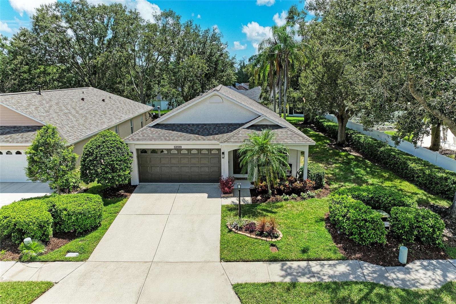Welcome to your peaceful retreat in the heart of Summerfield Forest, one of the most desirable neighborhoods in Lakewood Ranch. Unlike other Summerfield enclaves, Summerfield Forest features its own community pool — and with this home located right next door, you’ll enjoy all the benefits of a pool lifestyle without any of the maintenance. This delightful 3-bedroom, 2-bathroom home is boasting a host of recent upgrades that make it move-in ready. Step inside to an airy open floor plan with vaulted ceilings, large windows, and fresh interior paint (2025). All ceiling lighting has been updated to sleek LED flat fixtures and fans with remotes (2025), and new smoke detectors (2025) ensure peace of mind. The spacious living and dining areas flow seamlessly into the updated kitchen, which shines with brand-new granite countertops (2025), a large peninsula with storage and room for seating, and a complete suite of all-new stainless-steel appliances (2025). Just off the kitchen, the family room features custom built-in shelving and sliding glass doors that open to the screened lanai, creating an effortless indoor-outdoor lifestyle. The primary suite that’s tucked away offers a serene retreat with a walk-in closet and an en-suite bath featuring new quartz countertops (2025), updated plumbing fixtures and toilets (2025), a spa-like soaking tub, and a walk-in shower. Two comfortable guest bedrooms share a beautifully refreshed guest bath, also upgraded with quartz counters and new fixtures (2025). Beyond the interior, this home has been thoughtfully cared for inside and out. The exterior, porch, and lanai were freshly painted (2025), the garage floor has been newly refinished (2025), and the roof was replaced recently (2019). A brand-new sprinkler system (2025) keeps the landscaping lush and vibrant. Mechanically, the home is equally strong, with a new A/C unit (2021) still under a transferable maintenance contract through July 2026 and a new thermostat installed (2025). Fences are permitted within the community in accordance with HOA guidelines, and residents of Summerfield Forest also enjoy low HOA fees. The neighborhood offers access to Lakewood Ranch’s many amenities, including parks, Heron’s Nest Nature Park, walking trails, and playgrounds, as well as convenient shopping and dining. With top-rated schools nearby and the Gulf Coast’s stunning beaches just a short drive away, this home provides the very best of Florida living.