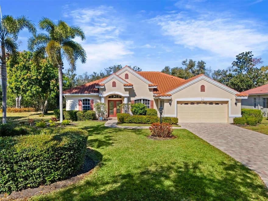 Located behind the gates of Treymore at the Villages of Palm Aire, this Arthur Rutenberg-designed
residence is positioned on an oversized 0.37-acre homesite, offering privacy, elegance, and timeless
design. A 2023 paver driveway and brick walkway lead to glass double entry doors, welcoming you into
an open, light-filled floor plan designed for effortless living and gracious entertaining. Luxury vinyl plank
flooring (2023) flows throughout the main living areas, creating a cohesive and updated aesthetic. The
spacious great room opens through expansive sliding glass doors to a screened lanai featuring a
solar-heated pool (2022) and retractable awning — a private outdoor retreat perfect for evening
gatherings or quiet mornings by the water. The kitchen is both stylish and functional, appointed with
staggered cabinetry, gas range, double ovens, tile backsplash, pendant lighting, and thoughtfully
integrated roll-out shelving that enhances organization while maintaining clean design lines. The
primary suite offers a serene retreat with dual walk-in closets and a well-appointed bath featuring dual
vanities, a walk-in shower, soaking tub, and private water closet. A split-bedroom floor plan ensures
comfort and privacy, with two guest bedrooms positioned opposite the primary suite. Recent
improvements include washer, dryer, and refrigerator (2025), gas water heater (2025), tile roof (2021),
updated A/C system (2019) with ducts cleaned and UV light added (2025), Mylar window and slider
film, and a portable gas generator — reflecting consistent pride of ownership. Treymore residents enjoy
the security of a gated enclave just moments from optional membership at Palm Aire Golf & Country
Club. Offering two championship golf courses, Har-Tru tennis courts, pickleball, fitness facilities, dining,
and a vibrant social calendar, Palm Aire delivers a true country club lifestyle without mandatory
membership. Conveniently located near UTC Mall, SRQ Airport, downtown Sarasota and Bradenton,
and approximately 14 miles to Siesta Key, Lido Key, and Bradenton Beach.