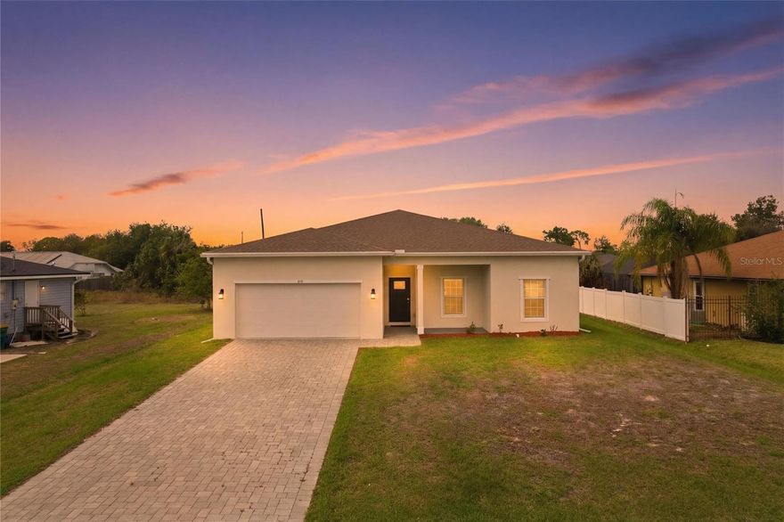 UNFURNISHED ANNUAL 4 bedrooms, 2 bathrooms, and 1,710 square feet of thoughtfully designed living space. This attractive single-story residence features a clean, modern exterior, a classic hip-roof design, and a paver driveway leading to a spacious two-car garage. Step inside to a bright, open-concept floor plan where the kitchen, living room, and dining area flow seamlessly—perfect for both entertaining and everyday living. Tile flooring extends throughout the entire home, providing a cohesive, low-maintenance finish ideal for Florida living. High ceilings, recessed lighting, and abundant natural light enhance the open and airy atmosphere. The modern kitchen showcases white cabinetry, stainless steel appliances, a breakfast bar, and pendant lighting, all overlooking the main living areas. The laundry room is conveniently located off the kitchen and includes a washer, dryer, and utility sink. Sliding glass doors provide easy access to the outdoor space. The primary suite is privately located on one side of the home, offering a peaceful retreat complete with his and her walk-in closets, a dual-sink vanity, a walk-in shower, and a private toilet room. On the opposite side of the home, three additional bedrooms—each with built-in closets—share a full bathroom. Any of these rooms can easily serve as a home office, guest room, gym, or flex space to suit your lifestyle. Out back, enjoy a covered patio with ceiling fan, perfect for relaxing or entertaining year-round. The large backyard provides ample space to add a pool or create your own custom outdoor oasis. The home’s HVAC system is located within the conditioned space, meaning the heating and cooling equipment is placed inside the insulated, climate-controlled areas of the home. This design helps improve energy efficiency, provides easier maintenance access, and ensures the system operates in a protected environment for reliable year-round comfort. Additionally, the home features a separate 50-amp breaker in the electrical panel and is prewired to specifically handle an 8,500–15,000-watt generator, offering peace of mind and convenience during power outages. The property is also connected to public water, eliminating the need for a well. Situated in a well-established neighborhood close to shopping, dining, schools, and all that Port Charlotte has to offer, this home is move-in ready, low maintenance, and thoughtfully designed for modern Florida living.