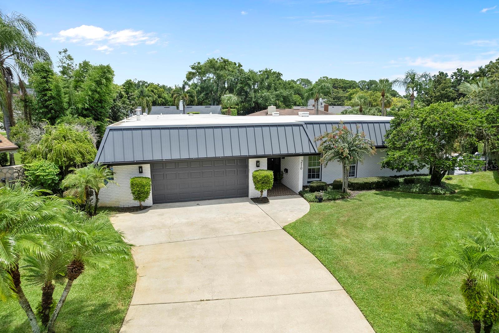 Experience the ultimate in lake lifestyle living with this beautifully renovated four-bedroom, three-bath home located on the canal to Lake Maitland—one of the most desirable lakes on the Winter Park Chain-of-Lakes. Tucked away on a quiet cul-de-sac just one house from open water, this home offers the perfect blend of waterfront serenity and access to vibrant city amenities. Inside, the residence has been thoughtfully updated over the past six years, preserving its character while incorporating modern finishes. Refinished original hardwood floors flow through the main living areas, and the remodeled kitchen features Quartz countertops, a glass backsplash, and opens to a bright, sunlit family room with three sets of French doors that lead to the pool, side deck, and expansive outdoor living areas. The spacious living room and a stylish media/den with a striking marble accent wall provide comfortable spaces to relax or entertain. The primary suite features French doors to the pool and a luxurious en suite bath with a soaking tub, large glass shower, dual sinks, and a showstopping glass walk-in closet. Two additional bedrooms share a Jack-and-Jill bath, and a fourth bedroom with a full bath adds flexibility. Outdoor living takes center stage with a completely renovated pool featuring a HeatWave heating and cooling system and a sand-blasted marble deck. A generous covered lanai offers plenty of space to relax, grill, and entertain, and includes a 20’ x 15’ SunSetter motorized awning with LED lighting for shade and ambiance. Enjoy canal-front lounging on the WearDeck composite dock, or hop on your boat or jet ski from the covered boathouse with hoist lift and floating dock. Recent upgrades include a new Bosch A/C system (2024) with 10-year warranty and a new roof (2019) with transferrable warranty. Located minutes from Park Avenue in downtown Winter Park, this home also offers quick access to Maitland’s cultural corridor with its growing list of restaurants, Lake Lily Park, the Maitland Public Library, and the popular Lake Lily Farmers’ Market. This is a rare opportunity to enjoy the best of waterfront living in an unbeatable Central Florida location.
