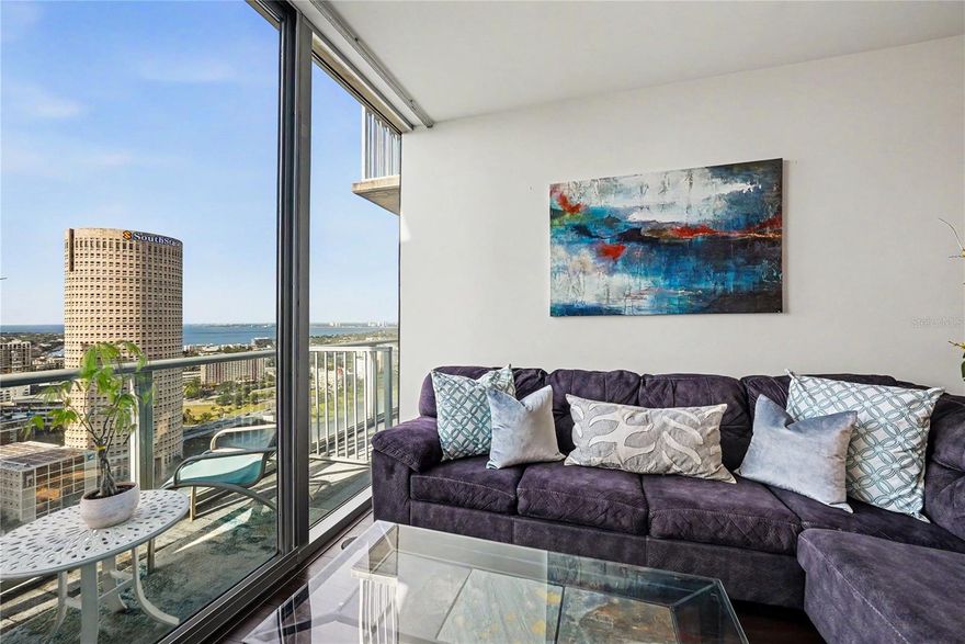 RARELY AVAILABLE SKY COLLECTION Skypoint 26th floor residence showcases the most desirable and largest one-bedroom, one-bath floorplan, offering 898 sqft of generous living space. This exceptional home features two semi-private balconies with opening sliders, providing seamless indoor-outdoor living and breathtaking water and city skyline views. Enjoy elevated downtown living with an expansive layout, finished ceilings, and abundant natural light throughout. A full laundry closet accommodates a full-sized washer and dryer for added convenience. This is a rare opportunity to bring your own vision and custom finishes to a premier residence with unmatched potential. This beautifully maintained residence sits high above the city, offering stunning water views that stretch over Curtis Hixon Park and beyond. Start your mornings with coffee on EITHER balcony while taking in the views and wind down your evenings with the glow of city lights. Inside, you’ll find sleek wood floors throughout, expansive floor-to-ceiling windows, and an open layout that seamlessly blends comfort and style. The kitchen and living spaces are perfect for entertaining or simply enjoying the vibrant city below. Located in a secure, full-service building, SkyPoint places you steps from Tampa’s best: the Riverwalk, Water Street, downtown entertainment, top-rated dining, and the University of Tampa. With easy access to I-275 and I-4, commuting is effortless. Skypoint wonderful amenities include: 24/7 concierge and controlled building access, a resort-style pool deck and spa, landscaped outdoor terrace, clubroom with billiards and media space, state-of-the-art fitness center, and on-site dining options in the building’s mixed-use ground level. Whether you're seeking a dynamic downtown lifestyle or a high-end investment, this SkyPoint gem delivers. Don’t miss the opportunity to own one of Tampa’s premier high-rise condos.