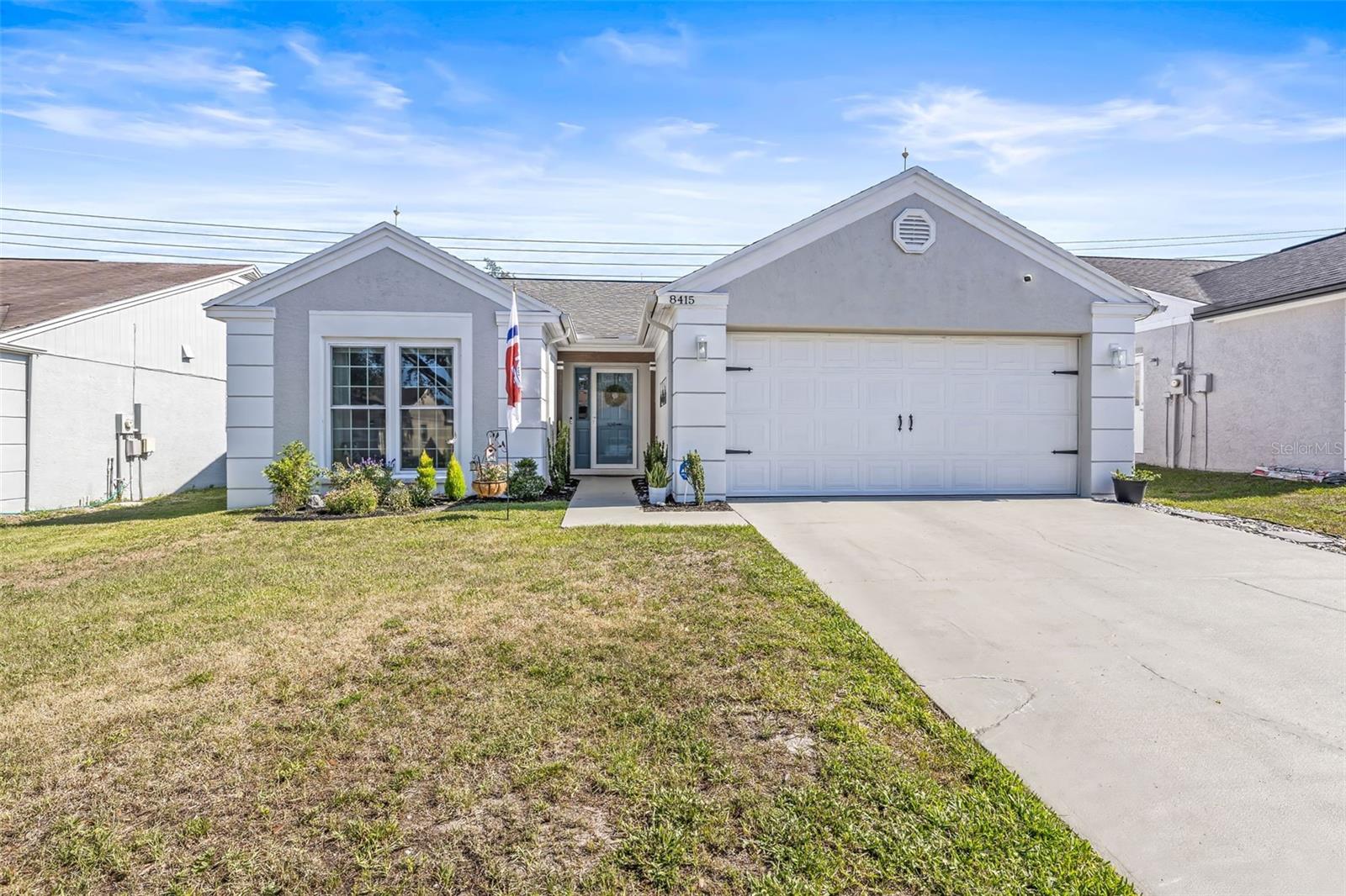 Welcome to this beautifully maintained 3-bedroom, 2-bathroom split-plan home with a 2-car garage, nestled in the highly sought-after Jasmine Trails community. Step inside to a light-filled, open floorplan featuring cathedral ceilings and durable laminate flooring throughout, with ceramic tile in the kitchen and bathrooms. The spacious living and dining areas are ideal for relaxing or entertaining. The large kitchen provides ample counter and cabinet space, perfect for preparing family meals or hosting guests. The generous primary suite includes a walk-in closet and a private en-suite bathroom with a walk-in shower, offering a quiet retreat at the end of the day. Both guest bedrooms are impressively sized to accommodate any lifestyle needs such as a home office or gym. All windows have been replaced with impact-resistant glass, offering added peace of mind during storm season and contributing to lower electric bills year-round. Updated lighting fixtures and ceiling fans throughout the home enhance both style and comfort. The home also features a whole-home water softener system for improved water quality and added convenience. Enjoy Florida living year-round from your screened-in patio, or let pets and little ones play freely in the partially fenced backyard with 6-foot white PVC privacy fencing. Pets allowed with a $250 non-refundable pet fee. Residents of Jasmine Trails enjoy access to a community clubhouse, pool, and shuffleboard courts. There is also an option for secured boat and RV storage for an additional fee. Ideally situated close to beaches, golf courses, schools, shopping, dining, and major highways, this home offers easy commutes throughout the Tampa Bay area. Don't miss your opportunity to live in one of the area's most desirable communities schedule your private tour today! Home is rented unfurnished and available July 15th for move-in.