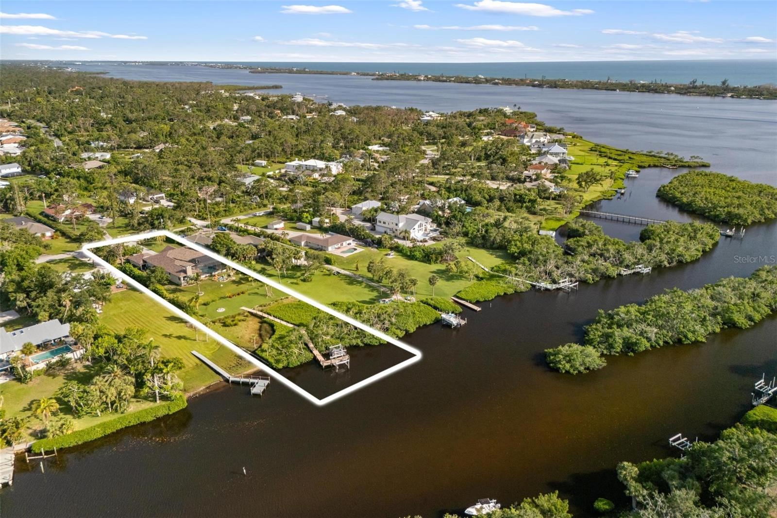 This custom estate is truly in a class of its own—look no further. Built in 2003, this exceptional waterfront retreat is set on over an acre of lush landscaped grounds, overlooking the serene and peaceful waters of Forked Creek. Designed to fulfill your coastal living dreams, this property is the perfect blend of privacy, natural beauty, and elegant comfort.
Surrounded by nature’s bountiful flora and fauna, the yard features mature coconut palms, banana trees, three varieties of mango, olive trees, and more—creating a tropical oasis that is both serene and inviting. The partially fenced backyard also includes a spacious outdoor fire pit, ideal for entertaining, watching the most beautiful sunsets light up the sky or quiet evenings under the stars.
Stepping inside this spacious (3487 ft. under air) abode you enter the sunset room, where you’ll be greeted by spectacular water views. First, you see the crystal blue heated pool and spacious outdoor entertaining spots. Then, turn your attention to the sweeping views of the manicured yard, private wetland preserve, boat dock accommodating up to a 28 ft. vessel, and 2 separate adjoining lifts for 2 jet skis. You’ll all be set for your aquatic adventures on tranquil Forked Creek and beyond. You’re just a few minutes away from Lemon Bay, the intracoastal, and local beaches. Outdoor amenities in this bird watcher’s paradise include an outdoor shower, fire pit, and abundant wildlife.
Designed for entertaining, the eat-in kitchen features an open floor plan, copious cherrywood cabinets, granite counters, a center island, wrap-around high-top seating, glass cooktop, wall oven, cozy dining alcove, walk-in pantry, and an electric fireplace in the adjoining great room.
Relax and entertain guests with brilliant sunsets in the westerly facing, granite-wrapped bar room/man cave which sports a built in, commercial grade dual kegerator with built-in taps, mirrored wall of glass shelves, spacious cabinets and a wood-burning fireplace.
A large laundry/craft room complete with additional cabinets, closet, and counter space provides for convenience and efficiency in this essential task.
Double doors from the sunset room lead into the spacious, private, and beautifully appointed primary bedroom suite. Enjoy peaceful water views, a generous walk-in closet, and a separate study or home office—ideal for quiet productivity. The luxurious en-suite bath completes the space with dual vanities, a Roman-style walk-in shower, and a soothing Jacuzzi tub.
The attached, oversized garage/workshop is capable of fitting four vehicles with room to spare, and is lined by 10 ft. tall, custom-built-in storage cabinets. Abundant outdoor parking is also provided.
Additional amenities include a formal dining room, tray ceilings throughout, newer roof, fresh paint, hurricane windows and double front doors, and a retractable hurricane barrier across the pool seating alcove. This home has remained unaffected by Mother Nature’s hurricane forces. With no HOA, this property comes with an optional membership in a private gulf beach club on Manasota Key. Energy efficiency is at the forefront with the latest Tesla Powerwall 3 system, offering the option for complete independence from the grid—drastically reducing energy bills and increasing peace of mind. For added convenience, the sellers offer the option to purchase the home fully furnished under a separate agreement.