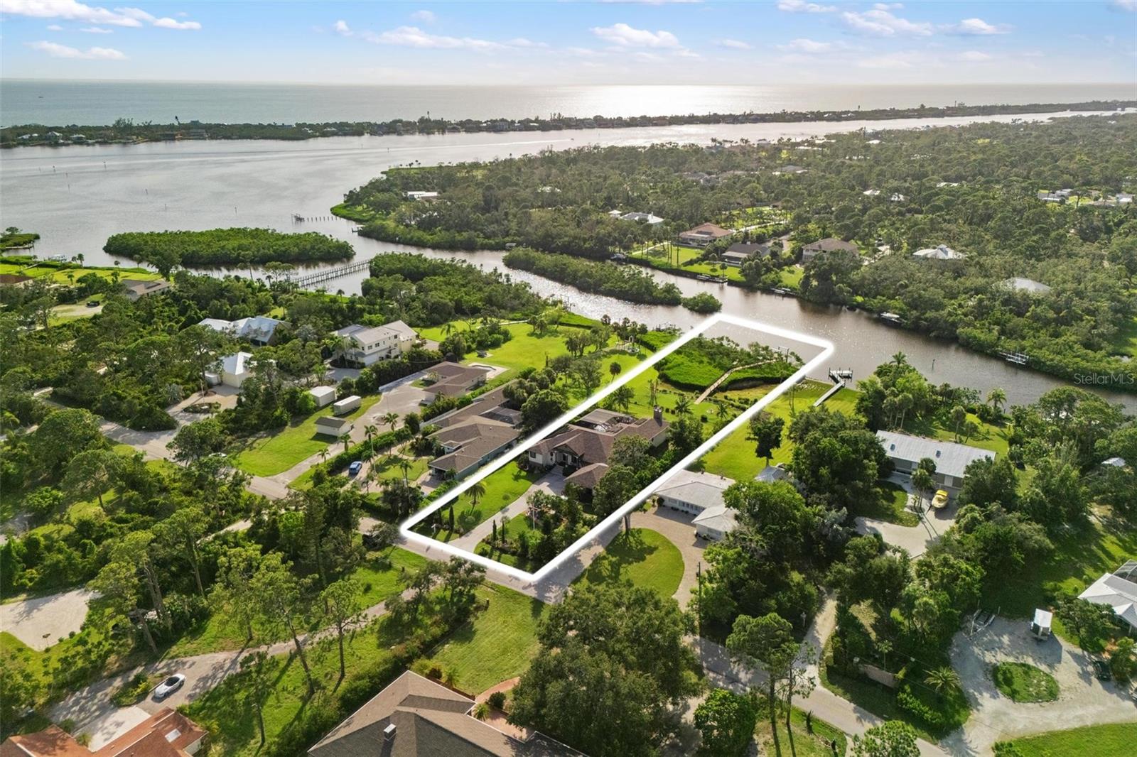 New Price Improvement! Built in 2003, this exceptional custom estate sits on over an acre of lush, landscaped grounds overlooking the tranquil waters of Forked Creek. Designed to capture the essence of coastal living, it offers the perfect blend of privacy, natural beauty, and refined comfort.
The tropical grounds feature coconut palms, banana trees, multiple mango varieties, olive trees, and more—creating an inviting oasis. A heated pool, spacious fire pit, and expansive entertaining areas provide the ideal setting for lively gatherings, breathtaking sunsets, or quiet evenings under the stars. With a private boat lift and two jet ski lifts, you’re minutes from Lemon Bay, the Intracoastal, and Gulf beaches.
Inside, 3,487 sq. ft. under air includes a sunset room with stunning views, an open kitchen with cherrywood cabinetry, granite counters, island, wrap-around seating, wall oven, glass cooktop, and pantry, all flowing into a great room with fireplace and dining alcove. Additional highlights include a granite-wrapped bar room with dual kegerator and fireplace, formal dining room, and a large laundry/craft room.
The private primary suite boasts serene water views, a walk-in closet, dedicated home office, and a spa-style bath with Roman shower, Jacuzzi tub, and dual vanities. The oversized garage/workshop features custom 10 ft. cabinetry, with abundant outdoor parking.
Upgrades include hurricane-impact windows/doors, new AC, newer roof, fresh paint, retractable pool alcove barrier, tray ceilings, and a dual Tesla Powerwall 3 system for true energy independence. This home has never sustained hurricane damage and comes with optional Gulf beach club membership.
No HOA, prime location, and every amenity designed for comfort—this coastal estate is truly a must-see!