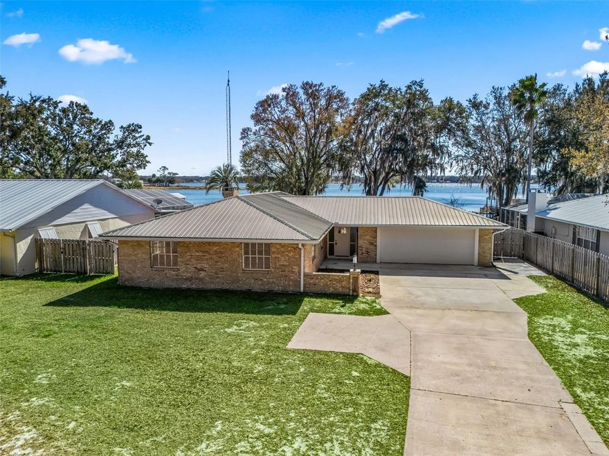 NEWLY RENOVATED!! Ready for Lake Life? Your Dream Home Awaits on Lake Weir! Seize this rare opportunity to own a charming brick home right on the shores of Lake Weir. This 3-bedroom, 2-bath home is perfect for those who love the water. With a metal roof and a spacious Florida room, you can enjoy panoramic lake views all year round. Have a boat or jet ski? You’ll love the convenience of your own dock to make the most of everything Lake Weir has to offer—whether it’s water skiing, fishing, or simply relaxing on the water. Just a short drive to The Villages for shopping, dining, and entertainment, or head to Ocala for more city conveniences. Whether you’re looking for a peaceful weekend retreat or a permanent lakeside residence, this home offers endless potential for both. Don’t miss out on lakefront living at its best! See list of updates under the paper clip!