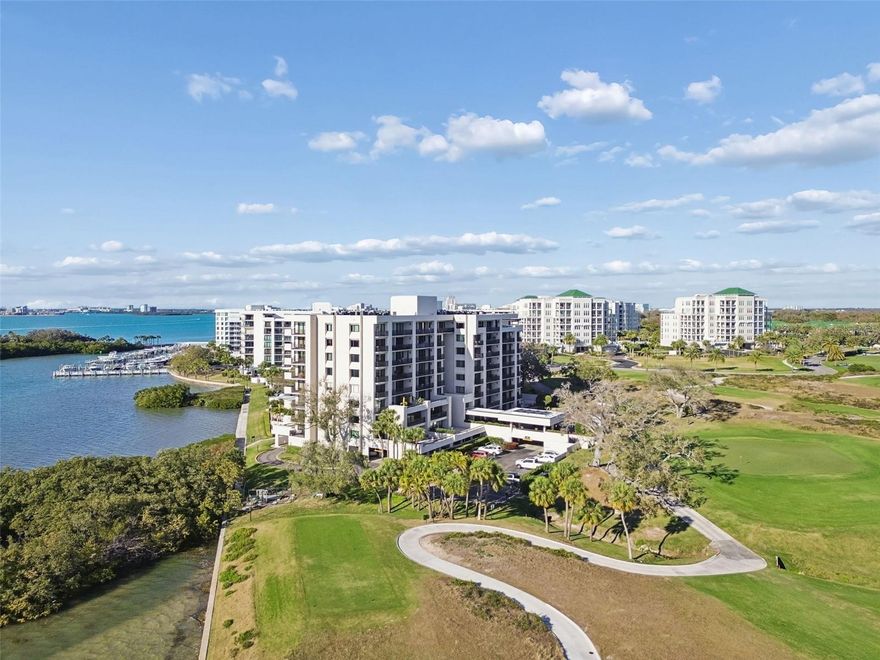 This is a rare opportunity to BYPASS the years-long waiting list to join the historic Belleair Country Club, established in 1897 and renowned for its exceptional amenities. Located on the 7th floor behind the gated entrance of this prestigious community, this stunning 2-bedroom, 2-bath condominium offers mesmerizing panoramic views of Belleview Island, the Sand Key Bridge, and the Intracoastal Waterway from a private balcony. The bright, open floor plan defines Florida living, featuring abundant natural light, walls of hurricane-rated sliders, and seamless indoor-outdoor living. The beautifully remodeled kitchen (2025) flows effortlessly into the dining and family rooms making it ideal for entertaining. A versatile guest bedroom includes a custom Murphy bed that opens to the living area for added entertaining space, with plantation shutter dividers available when privacy is desired. The spacious primary suite offers double closets and an en-suite bath with quartz countertops and a tub/shower combination. For added convenience, a hall laundry closet includes a washer and dryer. Residents enjoy a dog-friendly community with a heated pool, newly remodeled clubhouse, new hurricane windows in the common hall areas (2026), a new sprinkler system inside the entrance of each home (2026), new bike storage, manicured grounds, and close proximity to boutique shopping, local dining, attractions, and the sugar-sand beaches of the Gulf Coast. Private Club Members have access to two championship Donald Ross-designed golf courses, tennis and pickleball, a resort-style pool, spa services, a state-of-the-art fitness center, marina with boat slips available for rent (subject to availability) and fine dining. This high-and-dry community does NOT require Flood Insurance.  Don’t miss this exceptional opportunity to experience luxury living in one of Belleair’s most sought-after community.