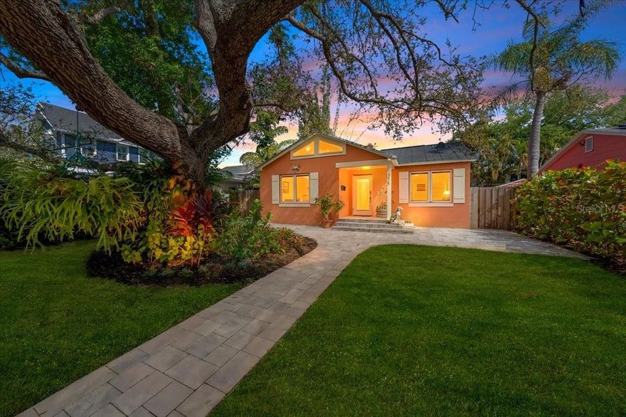 Welcome to the Old Southeast's most unique bungalow, perfectly situated in a non-flood zone just steps away from the scenic 13-acre Lassing Park. This incredibly charming home offers an unbeatable location only 4 minutes from downtown St. Pete while maintaining a true neighborhood feel. Step out your front door to views of the blue water, the downtown St. Pete and Tampa skylines, and the active waterfront filled with kiteboarders, kayakers, and boaters. The interior features 3 bedrooms plus a flex office and 2 bathrooms, highlighted by original hardwood flooring and a retro-style free-standing wood fireplace in the main living room. Natural light pours into the home through European-style lighting, skylights, and solar tubes. Modern updates include a durable metal roof, all-new electrical throughout, and a whole-home water filtration system. The exterior is a private oasis with a massive back patio for entertaining that already includes hot and cold water hook-ups for a future outdoor kitchen. The grounds feature new perimeter pavers and mature landscaping maintained by a Rainbird sprinkler system on a private well. A stunning oak tree in the front yard provides shade and the perfect spot for a swing. The property includes a massive 3-car garage with a car lift and alley access. This garage is separately metered and offers the potential to be converted into a home gym or an ADU. This is a one-of-a-kind home that must be seen to be appreciated.