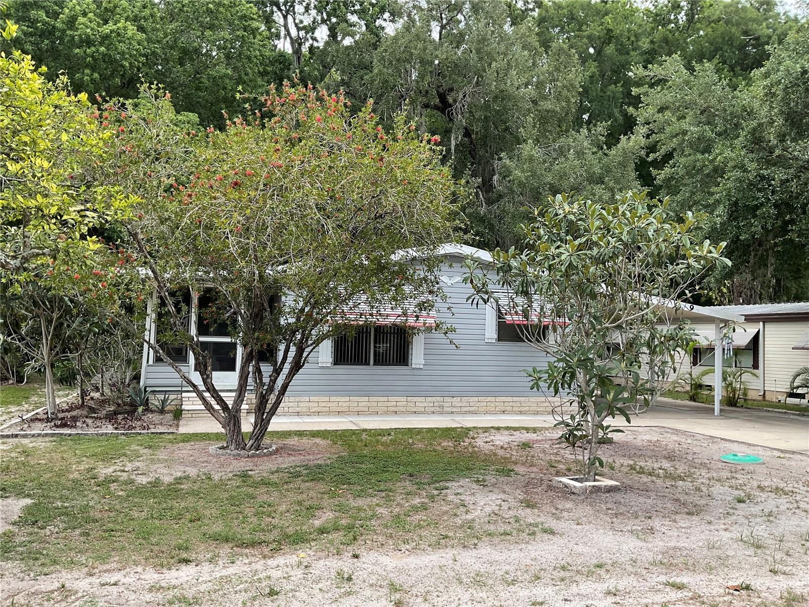 Welcome to the Continental Country Club an active 55+ community convenient to shopping, restaurants, and The Villages. This 1985 2 bedroom 2 bath double wide manufactured home has Laminate and Carpet throughout, a very spacious side & back screened lanai.You have a laundry room and the washer and dryer are included. This home offers an oasis out back with decking for all your entertaining needs as well as privacy and beautiful woods and greenery. Don't miss your opportunity to own and be apart of an amazing community that offers arts & crafts, Billards / Table Tennis Room, Boating/ fishing, Bocce ball courts, Fitness center, Golf, Lending Library, Pool, Restaurant, Pickle ball / Tennis courts, Shuffleboard, Softball field & Pavilion, Veterans Memorial park, Woodwork shop all located inside this friendly community!