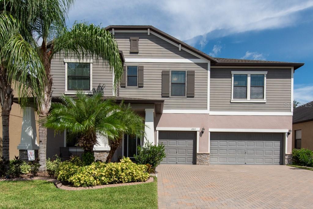 Spacious design, modern comforts, and resort-style amenities come together in this stunning 5-bedroom, 3-bathroom home on a conservation lot in the sought-after Triple Creek community. With 3,730 square feet of living space, a 3-car garage, and a paver driveway, this home offers both beauty and functionality inside and out. A covered paver patio welcomes you into the tiled entryway, setting the stage for the thoughtfully designed layout. The formal dining room is perfect for entertaining, while the gourmet kitchen boasts a butler’s pantry, stainless steel appliances, granite countertops, an island with barstool seating, and a casual eat-in area. The family room, finished with tile floors, opens to a screened patio and fully fenced backyard—ideal for relaxing or hosting gatherings. Downstairs also features a private bedroom and full bathroom with shower/tub, perfect for guests or multigenerational living. Luxury vinyl plank flooring continues up the stairs and throughout all upstairs bedrooms. A sprawling open loft offers endless possibilities for a game room, media space, or home office. Three secondary bedrooms feature large closets and ceiling fans, while the upstairs bath includes dual sinks, a shower/tub combo, and a private commode. The primary suite is a true retreat, featuring LVP flooring, a ceiling fan, and a spa-like bathroom with dual sinks, a soaking tub, a walk-in shower, a private commode, and direct access to the laundry room for everyday convenience. This home is packed with upgrades, including UV light in the upstairs AC handler for cleaner air and allergy relief, gutters, a whole-house generator for peace of mind, a water softener, and curbing around the garden beds for a polished landscape. Crown molding, high ceilings, and ample storage further enhance the home’s appeal. Triple Creek residents enjoy two clubhouses with resort-style pools, a splash pad, a fitness center, tennis and basketball courts, playgrounds, a dog park, and scenic walking trails. This move-in-ready home combines space, style, and convenience in one of the area’s most desirable communities. **Free 1/0 Interest Rate Buy Down when using Melissa Rodriguez with Citywide Home Mortgage - ask Listing Agent for details**