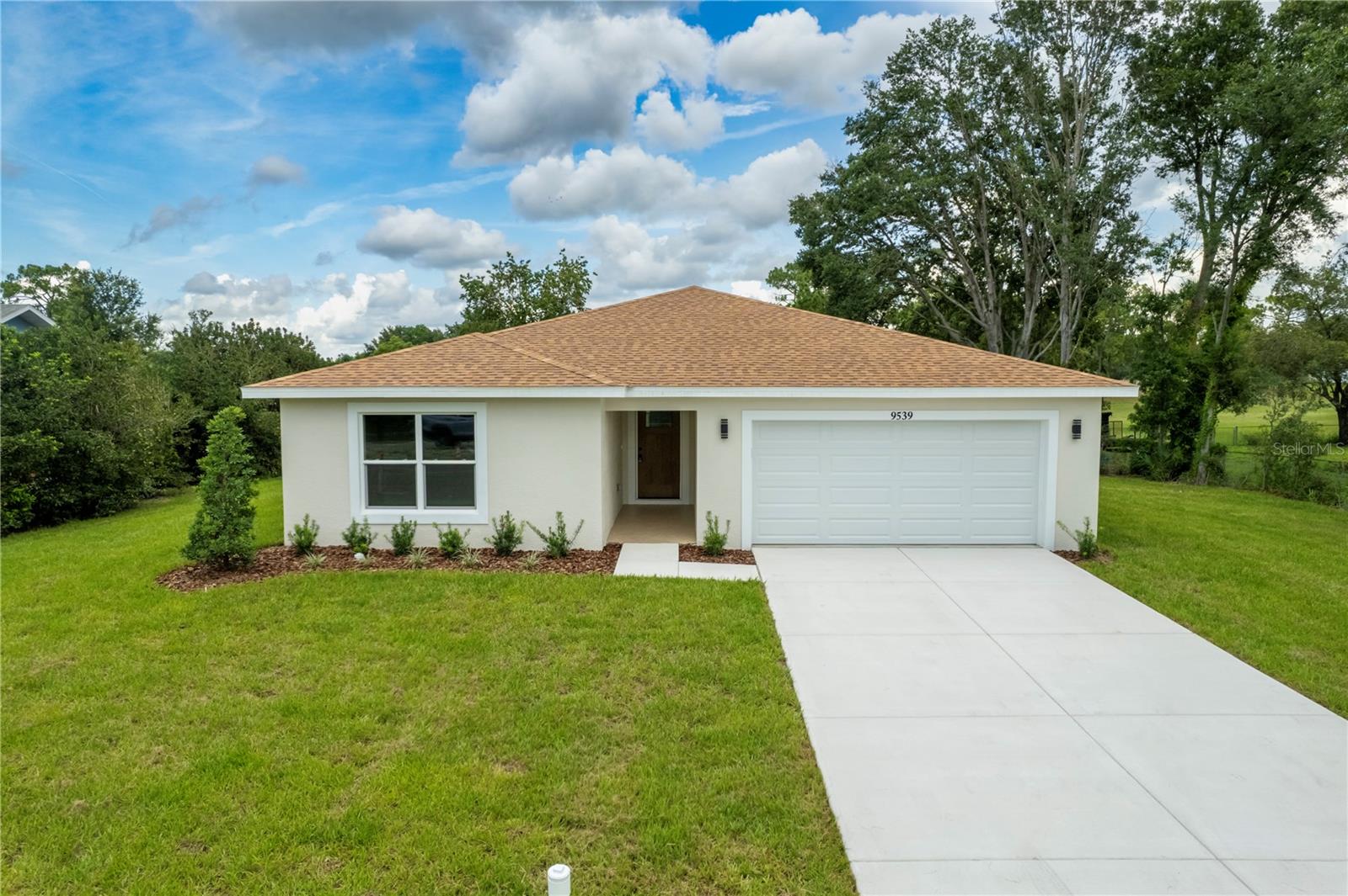 Welcome to this one-of-a-kind, newly built home in the heart of Spring Hill—crafted with love and attention to every detail. This stunning 3-bedroom, 2-bathroom residence offers 1,828 sqft of open, light-filled living space, thanks to an abundance of large windows that flood the home with natural light. The open floor plan is perfect for modern living, complemented by high-end finishes throughout, including waterproof luxury vinyl plank flooring, ceramic tile in the bathrooms and laundry room, and 34” kitchen cabinets paired with elegant Moen fixtures. The gourmet kitchen features Frigidaire stainless steel appliances, while the home also includes an LG washer and dryer for added convenience. The spacious master suite includes a luxurious bidet toilet and thoughtfully selected finishes. Designed to impress both inside and out, the home has been painted with Sherwin-Williams premium products, including one coat of primer and two coats of SuperPaint satin on the interior, and a Loxon pigmented primer with two coats of SuperPaint satin on the exterior. The impact-rated vinyl front and side garage doors offer durability and style, while the three-car garage—finished with epoxy-coated floors—provides ample space for parking, storage, or even a home gym. The front entrance and covered back porch also feature epoxy flooring, enhancing both function and curb appeal. Situated on an oversized lot with serene golf course views, this home is ideally located and move-in ready. Don’t miss your chance to make this exceptional property your own—schedule a private tour today!