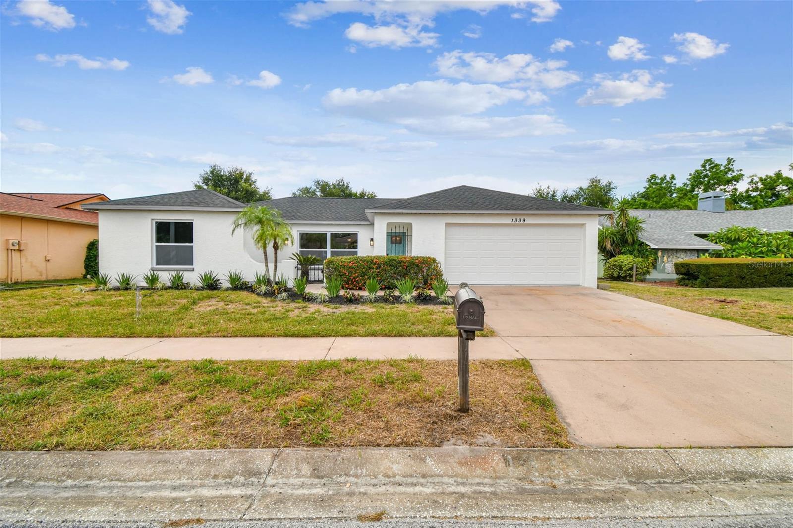 Welcome home to this beautiful and spacious 3 bedroom 2 bath Holiday home boasting over 1500 heated square feet and a 2 CAR GARAGE! If you are looking for the perfect starter or family home, look no further. GREAT OUTDOOR LIVING SPACES with a large back patio overlooking a huge fenced yard with enough room for a pool. This home has been TOTALLY RENOVATED by the owner and includes upgrades perfectly fit for a first time home buyer or growing family. The totally remodeled kitchen features solid wood cabinets, quartz countertops, stainless steel appliances, custom backsplash, and a designer faucet. The bathrooms feature the same level of upgrades including custom vanity, quartz countertops, designer tile, and new hardware. Other upgrades include NEW ROOF (2025), NEW IMPACT WINDOWS (2025), NEW GARAGE DOOR (2025), newer HVAC, newer water heater, new flooring throughout, new paint, new interior/exterior doors, new LED light fixtures, and MORE!! All of these amenities and upgrades are complimented by the unique curb appeal of the home which sits on a quiet street! This home has many desirable features and is a must see. Please call us or use ShowingTime to set up a showing today!