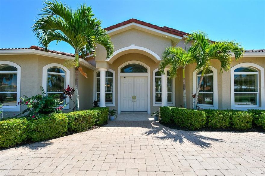 Pristine updated waterfront home on the preferable south-facing side of the canal in desirable Country Club Shores on the south end of Longboat Key. This comfortable residence was completely reconfigured and rebuilt in 2002 and 2017 with an effective year built of 2009.  The ceilings are now high providing a light-infused, sunny environment for this open plan, accessible 3-bedroom home with a den/office or fourth bedroom.  The spacious great room features ample sitting options and a gas fireplace overlooking the inviting pavered deck, swimming pool and attractive canal.  A stunning chef's kitchen shows handsome wood cabinetry, granite countertops, stainless appliances, natural gas range and wine refrigerator.  The primary suite provides two walk-in closets and a very spacious bathroom with dual granite vanities, soaking tub, and a large shower with bench.  The garden is designed for the enthusiast with flowering shrubs and many types of tropical fruit trees, including mango, avocado, fig, lime, and orange.  Enjoy daily boating from your large private dock with electric lift for fishing, taking in beautiful Florida sunsets, and boating to nearby waterfront restaurants.  You will love the oversized garage with its epoxy floor, central vac, and the paver circle driveway as an inviting entry to your home.  Offered turnkey furnished.  Country Club Shores is a popular boating community with deepwater canals, no bridges to the bay and very short distance to New Pass and out into the Gulf of Mexico.  Offering deeded beach access this location is just a few minutes from dining and shopping on world-renowned St. Armand's Circle and a few minutes' drive to the cultural activities of downtown Sarasota. Room Feature: Linen Closet In Bath (Primary Bedroom).