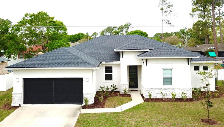 This beautifully designed, modern, energy-efficient home features a spacious open layout designed for both everyday living and entertaining. Located in the highly sought-after Trails B area of Palm Coast, this north-side location includes no HOA fees and convenient access to top-rated schools, parks, shopping, and daily amenities.
Built with solid concrete block construction, this Brite Home combines durability with low-maintenance living. The exterior showcases strong curb appeal with clean architectural lines, stone accents, a modern front door, full gutter system, and irrigation. Situated on a raised lot in Zone X (non-flood zone), this home adds peace of mind with no typical requirement for flood insurance.
Inside, you’ll find tile flooring throughout, high 9'4" ceilings, and a bright, open living space enhanced by custom recessed lighting. The kitchen is a standout feature, complete with quartz countertops, 42" soft-close cabinetry, upgraded appliances, a tiled backsplash, and a large island with stylish pendant lighting, great for gathering and entertaining.
A versatile flex space with custom glass doors and accent walls serves beautifully as a home office, but can easily function as an additional bedroom, media room, or multipurpose space tailored to your needs. The private guest suite with a full bath is excellent for visitors or multigenerational living.
The spacious primary suite serves as a relaxing retreat with tray ceilings, a double vanity, walk-in shower, separate water closet, and an oversized walk-in closet. 
Additional highlights include a custom laundry room with cabinetry and sink, modern ceiling fans throughout, and a covered lanai for outdoor relaxation.
The oversized garage features an epoxy floor and added overhead storage. A 10-year structural warranty adds peace of mind. located just minutes from local beaches, with easy access to St. Augustine, Jacksonville, and Daytona Beach, this home delivers the perfect blend of comfort, style, and convenience.
Washer, dryer, and hot tub are negotiable.
