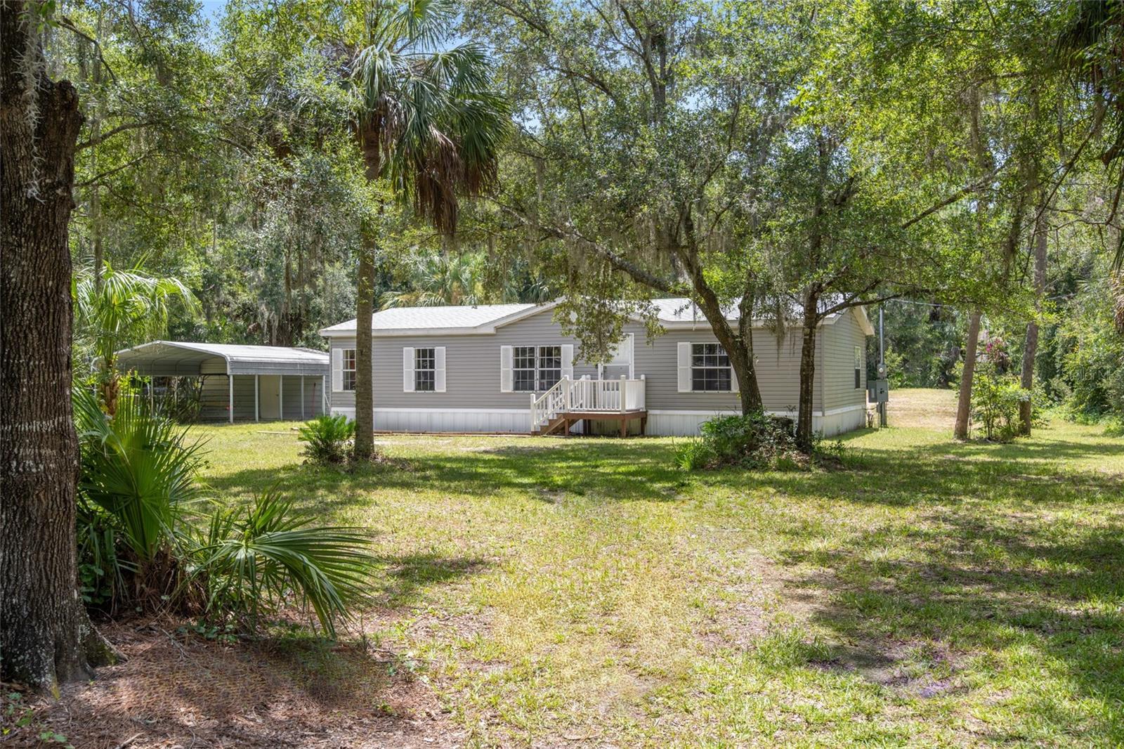 Enjoy peaceful Florida living just minutes from Crystal River’s world-famous springs, rivers, and outdoor recreation in this beautifully updated 3-bedroom, 2-bath home located in the quiet Spring Run subdivision. Set on a generous 1.08-acre lot, this 2004-built home combines comfort, convenience, and a great location close to kayaking, boating, fishing, and the Gulf Coast. Step inside to find fresh interior paint and brand-new vinyl flooring throughout, giving the home a clean, modern feel. The kitchen is spacious and functional with a breakfast bar, ample cabinetry, and stainless steel appliances—perfect for preparing meals or hosting casual gatherings. The living area features an electric fireplace, adding both warmth and ambiance for cozy evenings at home. The split-bedroom floor plan provides privacy and space, with the primary suite located on one side of the home and the two guest bedrooms and bath on the other. The master suite offers a relaxing retreat with its own private bathroom, while the additional bedrooms are ideal for family, guests, or a home office setup.
Several important upgrades have been completed, offering peace of mind for new owners. These include a new roof in 2020, a new water heater in 2019, and a new water softener installed in 2022. Outside, you’ll find a back deck overlooking the fully fenced backyard, creating the perfect space for outdoor dining, relaxing, or letting pets roam. The property also features a 2-car carport and an attached storage/workshop area, providing extra space for tools, hobbies, or lawn equipment. Situated just outside of Crystal River, this home offers convenient access to a wide range of outdoor activities. Swim with the manatees, kayak the clear waters of the springs, or explore the Gulf of Mexico—all just a short drive away. You’ll also find shopping, dining, medical facilities, and local schools nearby, making this location both quiet and convenient. Whether you’re looking for a full-time residence, a seasonal escape, or a weekend retreat close to Florida’s natural wonders, this Spring Run property is ready for you to move in and enjoy.