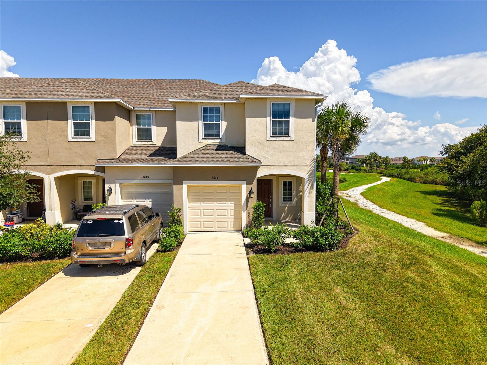 Discover serene Florida living at 8644 Lunar Skye St, Sarasota, FL 34241—a stylish end-unit townhome offering privacy, comfort, and scenic pond views in the desirable Skye Ranch community. This three-bedroom, two-and-a-half-bath home features a modern open-concept layout with a bright and welcoming main level that flows seamlessly into the kitchen, where a thick stone countertop provides both functionality and a touch of luxury—perfect for entertaining family and friends.
Upstairs, you'll find upgraded flooring throughout the second story, including the spacious owner’s suite with an en-suite bath and walk-in closet, as well as two additional bedrooms and a conveniently located laundry area. Storage is made simple with under-stair space, multiple closets, and a pantry just off the kitchen.
Enjoy the peaceful surroundings from your private patio overlooking the pond, with the added benefit of being next to a nature area for tranquil walks and outdoor enjoyment. Community amenities include access to two beautiful pools, and with low CDD fees, this home offers great value in one of Sarasota’s fastest-growing neighborhoods.