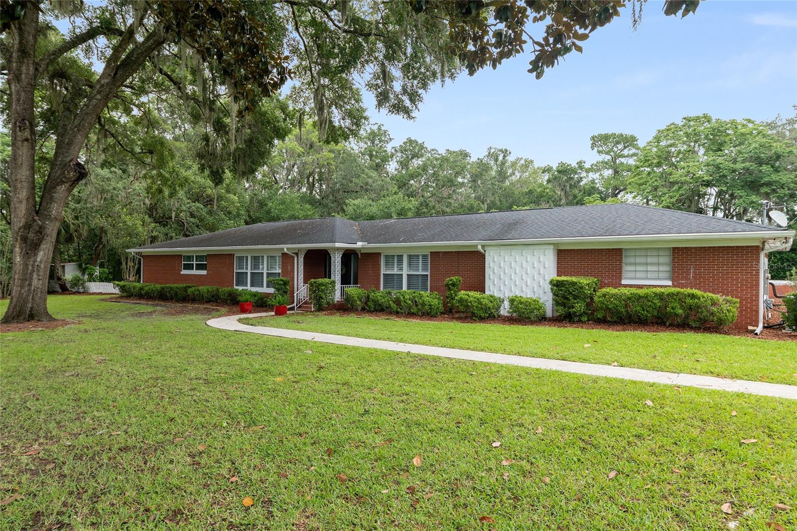 A minimum 3 month rental for this stunning fully furnished executive home nestled in a million-dollar neighborhood approx. 5 minutes from downtown Ocala. Large .85 acre corner lot w/ 2 car carport, fenced back yard, screened-in pool, & beautifully furnished. The expansive patio overlooks a lovely pool w/ lush landscaping for perfect Florida entertaining and fun! Well-equipped kitchen w/ wood cabinets, granite, updated stainless appliances, & plenty of space & storage. Large laundry room and pool bath off of the patio makes for easy entertaining & convenience. Huge primary suite offers new luxury king bedding, two huge walk-in closets, smart TV, a jacuzzi soaking tub, big shower, & lots of cabinet space. Bedroom two comes w/ a new luxury queen bed, smart TV, and decorated in a fun Florida motif. Bedroom three is equipped w/ twin Saatva beds, two closets, & cheerful whimsical decor. A lovely, nice sized hall bath with tub/shower services these two bedrooms. A separate living room & family room offers diverse living areas, as the family room comes with huge L-shaped comfy couch & 75" smart TV, games, along with a relaxing vibe whereas the living room off the kitchen & dining brings an upscale sophisticated vibe for easy entertaining. Weekly cleaning service is included along w/ pest control, pool service, yard service, utilities, & highspeed internet. You will love living in the exceptional & sought after neighborhood of Woodfields in beautiful ocala, Florida.