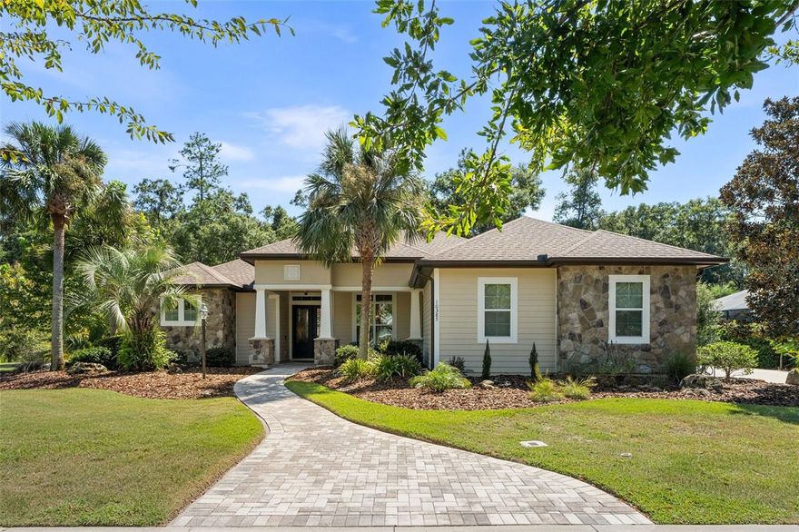 Discover a truly exceptional home in the esteemed Wilds Plantation community, perfectly situated on a private cul-de-sac lot. Step inside to find an open and inviting floor plan with high ceilings and stunning wood flooring that flows throughout the main living areas. The gourmet kitchen, a chef's delight, has been thoughtfully renovated and opens to a spacious great room. This central gathering space features a cozy gas fireplace and custom built-ins. Unique and convenient details, such as hidden charging outlets in kitchen drawers, ensure a clutter-free environment. The home offers a highly functional and well-designed layout. The luxurious master suite is a private sanctuary, complete with a spacious sitting area and his-and-her walk-in closets. The master bathroom is a spa-like retreat, boasting separate marble vanities and a beautiful walk-in shower. Two additional bedrooms are located on the opposite side of the house, while a large bonus room in the back corner offers flexibility and is conveniently located near a half bath. Outdoor living is a dream with this property's incredible backyard oasis. Designed for entertaining, it features a fantastic summer kitchen, a built-in gas fire pit, and a gorgeous heated, saltwater pool. The beautiful brick paver sidewalk extends from the front to the back, connecting all the outdoor spaces. The home's professional landscaping creates a park-like atmosphere that provides a sense of tranquility and privacy, as it backs up to a preserve. Practicality and convenience are key with features like a spacious laundry room with a sink and extra cabinets, and a transition "mud room" hallway leading to the three-car, side-entry garage. The home is also highly energy efficient, with its HVAC system housed in a conditioned space and insulation between the garage and the main house. Peace of mind with whole house generator! Located in the desirable Wilds Plantation community, this home is zoned for some of Gainesville's most sought-after schools, including Chiles Elementary, Kanapaha Middle, and Buchholz High. Don't miss the opportunity to own this remarkable property that combines luxury, comfort, and an ideal location. Schedule your private tour today!