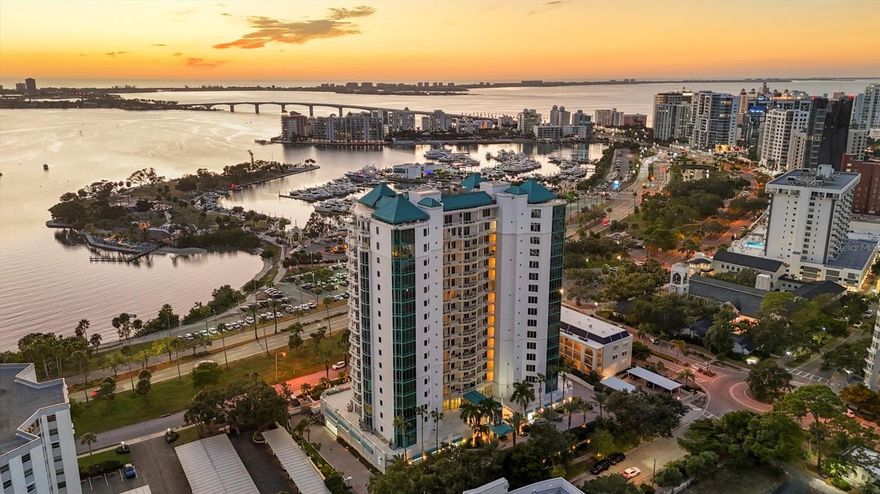 Set within Sarabande, one of downtown Sarasota’s most distinguished bayfront addresses, this third-floor residence blends comfort, functionality, and the opportunity for thoughtful modernization. The elevator opens directly outside the front door, leading into a spacious layout designed to capture Sarasota’s most breathtaking sunsets and sweeping views across Sarasota Bay. Inside, the great room is bright and inviting, with sliders opening to a private terrace and transom windows that frame the bay and beyond. The kitchen features solid-surface countertops, white cabinetry, and a generous eat-in nook, creating a bright and practical space for everyday living or casual entertaining. The primary suite offers two walk-in closets and an en-suite bath with a walk-in shower and vanity area, while the guest bedroom, with floor-to-ceiling windows and plantation shutters and a connecting Jack-and-Jill bathroom, ensures privacy and comfort. A den with French doors provides flexibility for an office or media space. Tile flooring flows through the main living areas, complemented by carpet in the bedrooms and den. The laundry room includes cabinetry and a utility closet for added convenience. The residence has been exceptionally maintained and offers a clean, livable foundation for a new owner to personalize. Beyond its walls, this home’s appeal lies in its setting within one of Sarasota’s premier luxury towers, steps from downtown dining, cultural venues, and the waterfront Bayfront Park. Sarabande’s reputation for prestige, full amenity suite including guest suites, and location makes this residence an extraordinary opportunity to enjoy Sarasota’s coastal city lifestyle, enhanced by a front-row seat to its most unforgettable sunsets.