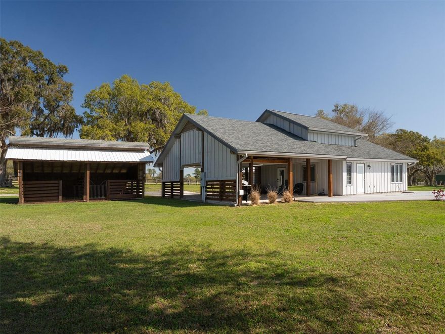 Situated in Morriston, just 15 minutes from the World Equestrian Center and 5 minutes from HITS, this 14+ acre fully fenced property supports equestrian and farm life and is dotted with majestic granddaddy oak trees, adding timeless beauty to the landscape. The unique, beautifully renovated two-story home features 2 bedrooms, 2 bathrooms, an office area, and a kitchen with stainless steel appliances. A covered carport with hay storage adjoins the home, and just steps away is a 2-stall horse barn, providing convenient access for daily horse care. The property also includes an in-ground pool, perfect for relaxing while enjoying the surrounding acreage. Additional structures include a detached garage/workshop and a metal pole barn, offering ample space for equipment, storage, or projects. Experience a peaceful rural lifestyle in this beautifully renovated home in the heart of Florida’s horse country.